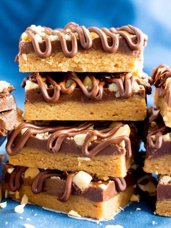 No Bake Peanut Butter Bars (Healthy): the ultimate healthy no bake peanut butter bars—just 5 ingredients, with thick layers of chocolate & peanut butter, a crunchy topping & velvety chocolate drizzle. #PeanutButterBars #Healthy #NoBake #Chocolate #PeanutButter | Recipe at BeamingBaker.com