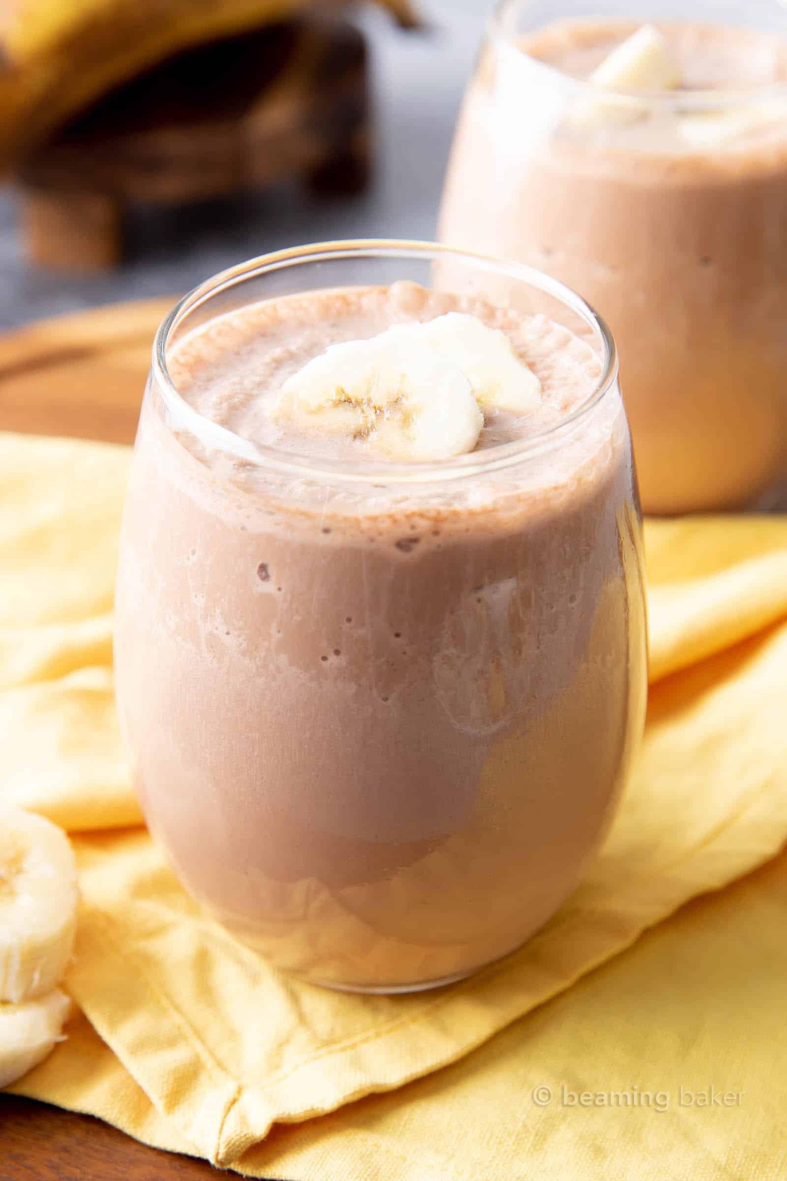 Chocolate Banana Vegan Protein Shake Recipe: creamy ‘n delicious chocolate banana protein shake made with just 4 ingredients. 22 grams of plant-based protein in the best vegan protein shake recipe! #Vegan #Chocolate #Banana #Protein #Shake | Recipe at BeamingBaker.com