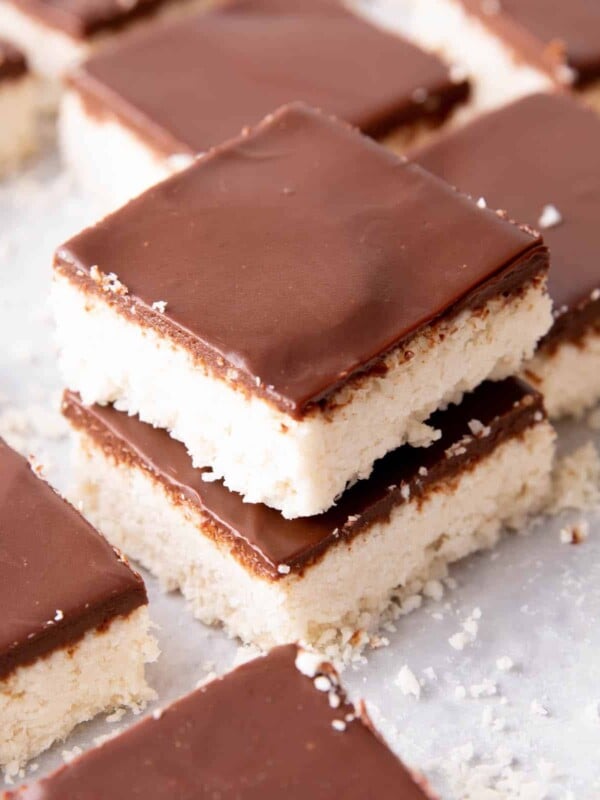 Keto Coconut Chocolate Bars: decadent keto coconut bars topped with a velvety layer of rich dark chocolate. The best keto coconut chocolate bars—Low Carb, super easy to make and mouthwateringly good! #Keto #Coconut #LowCarb #KetoBars | Recipe at BeamingBaker.com