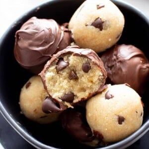 Healthy Cookie Dough Truffles: the ultimate healthy edible cookie dough recipe yields rich ‘n satisfying healthy cookie dough bites wrapped in velvety chocolate. #Healthy #CookieDough #Edible | Recipe at BeamingBaker.com