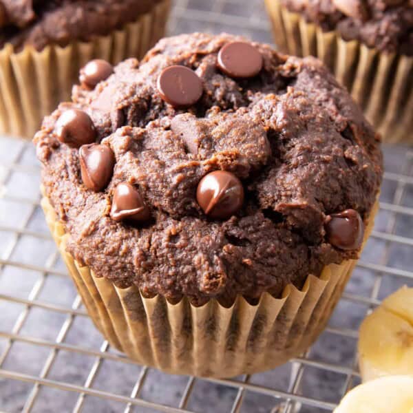 Healthy Banana Chocolate Chocolate Chip Muffins: tender & moist rich chocolate banana muffins. The best healthy chocolate banana muffins—fluffy & fudgy, deep chocolate brownie flavor. SO GOOD! #Healthy #Chocolate #Banana #Muffins | Recipe at BeamingBaker.com