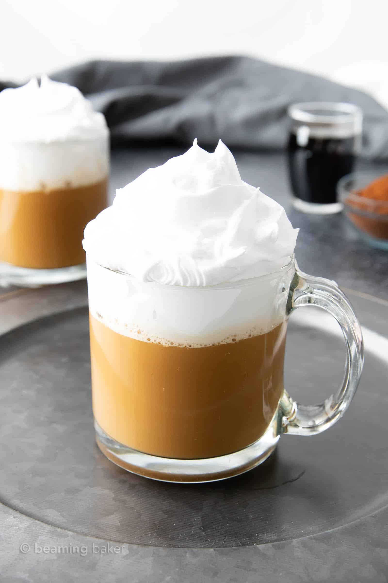 hot white russian in a heatproof glass mug with whipped cream on top