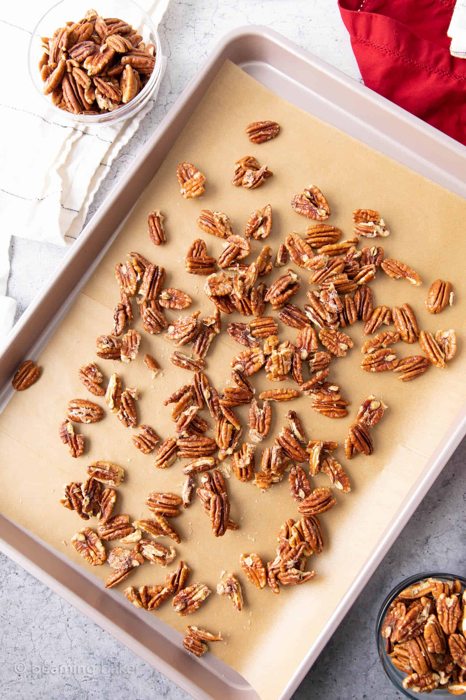 Baking workstation with keto candied pecans cooling on the baking sheet