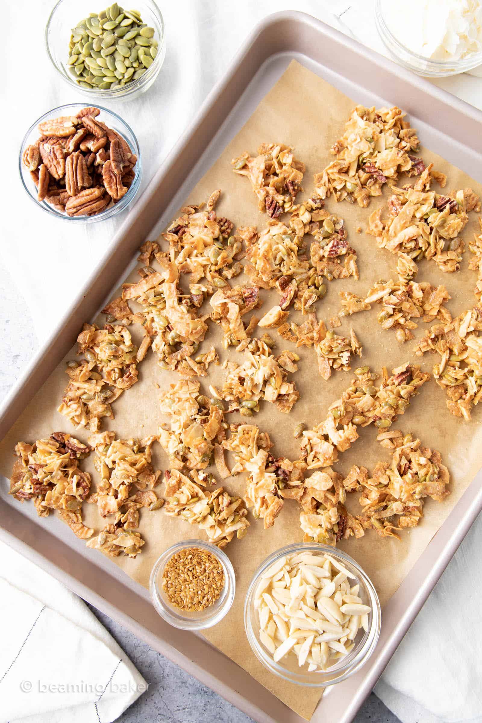kitchen table with keto coconut clusters and ingredients like pumpkin seeds and pecans
