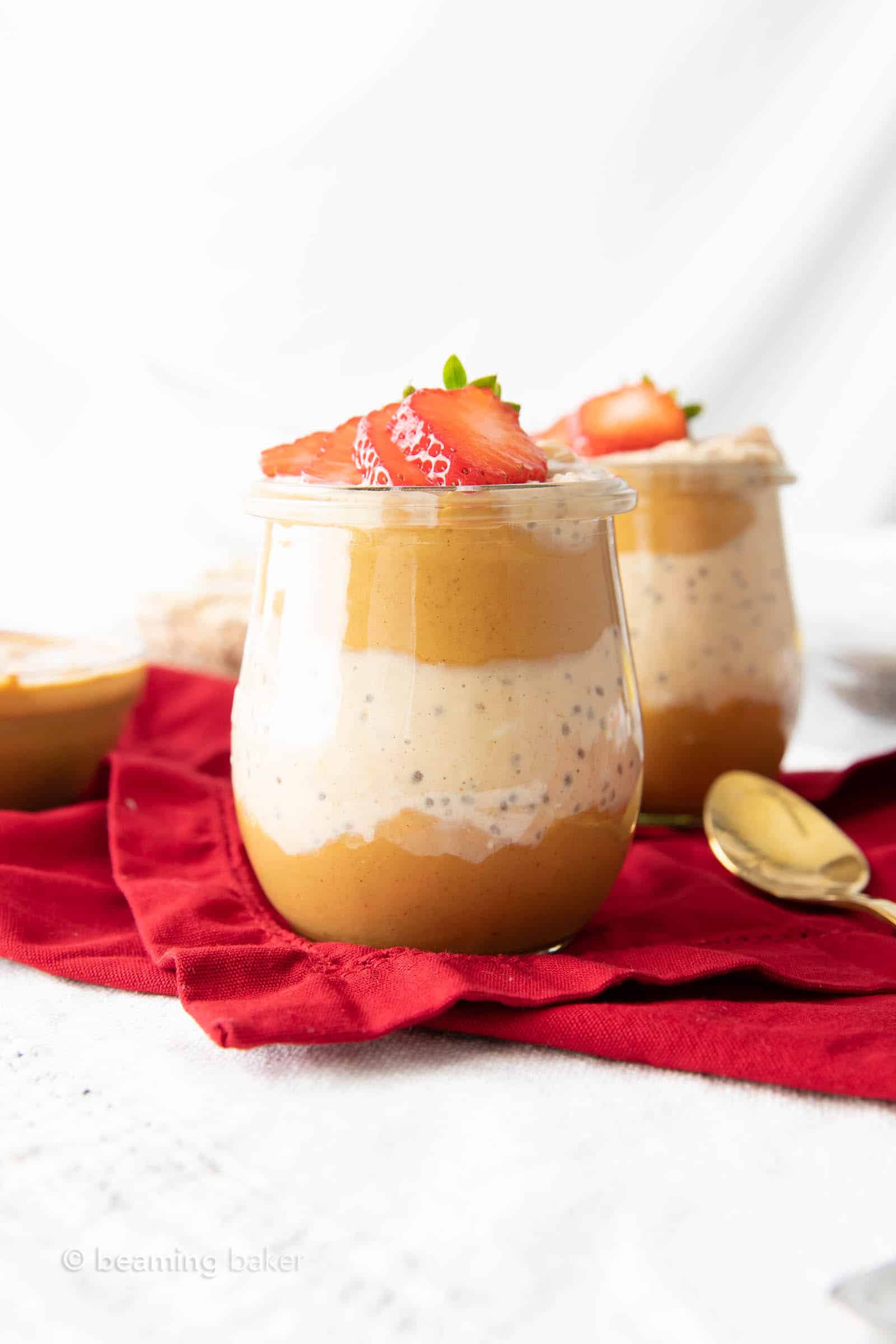 Two jars of this peanut butter overnight oats recipe with a golden spoon
