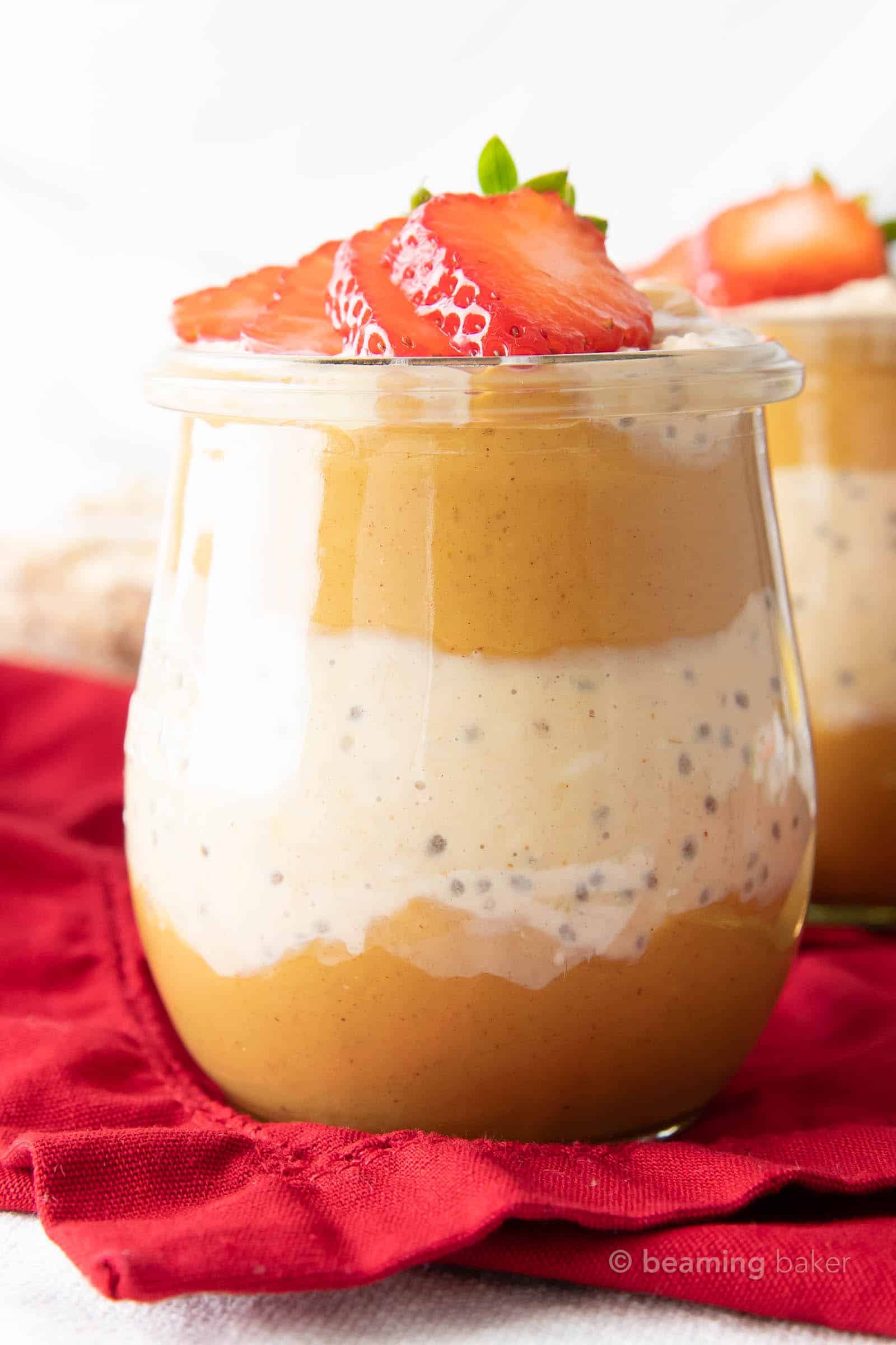 Super closeup shot of peanut butter overnight oats layered with peanut butter and topped with strawberries