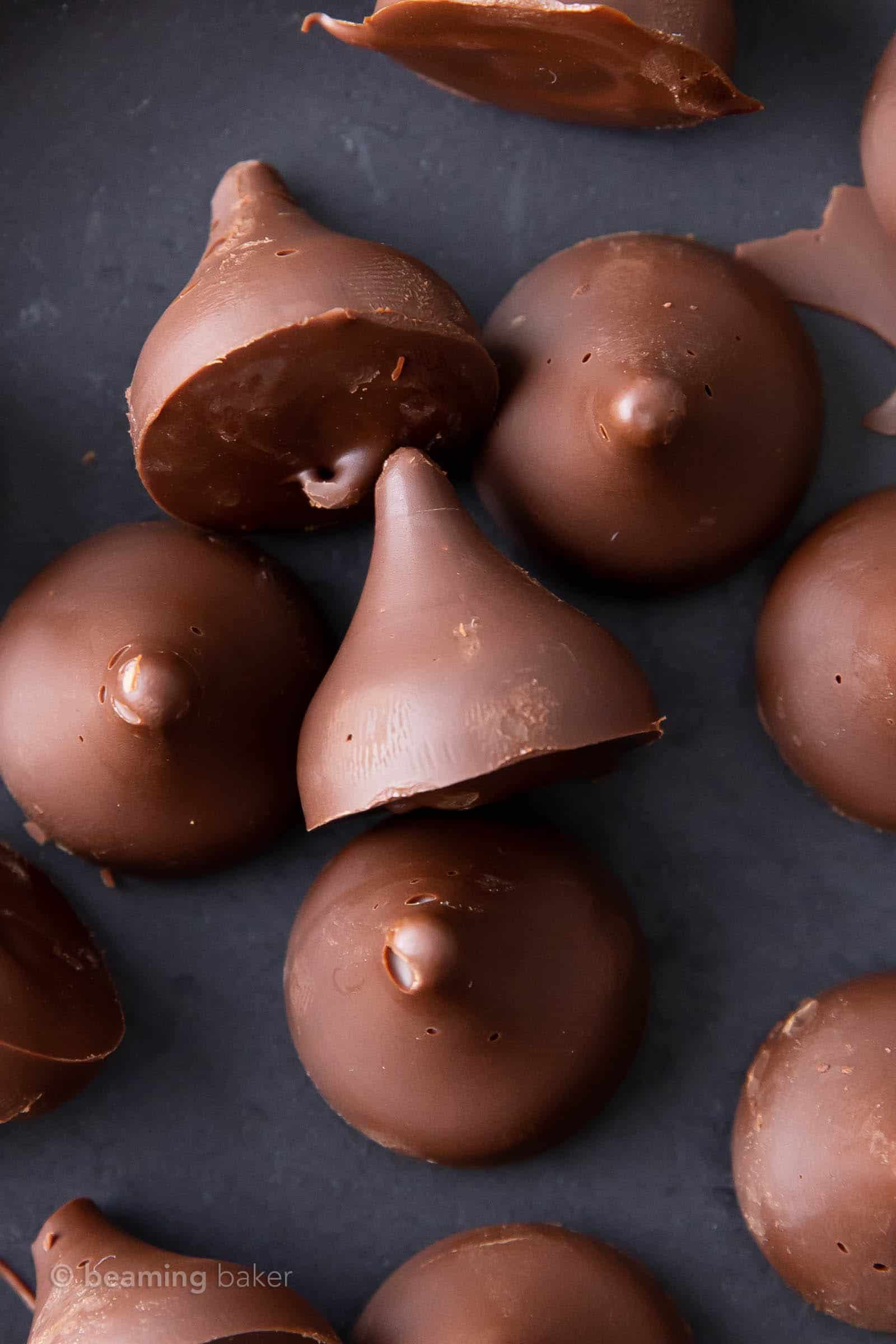 super close up of homemade vegan Hershey kisses on a black plate