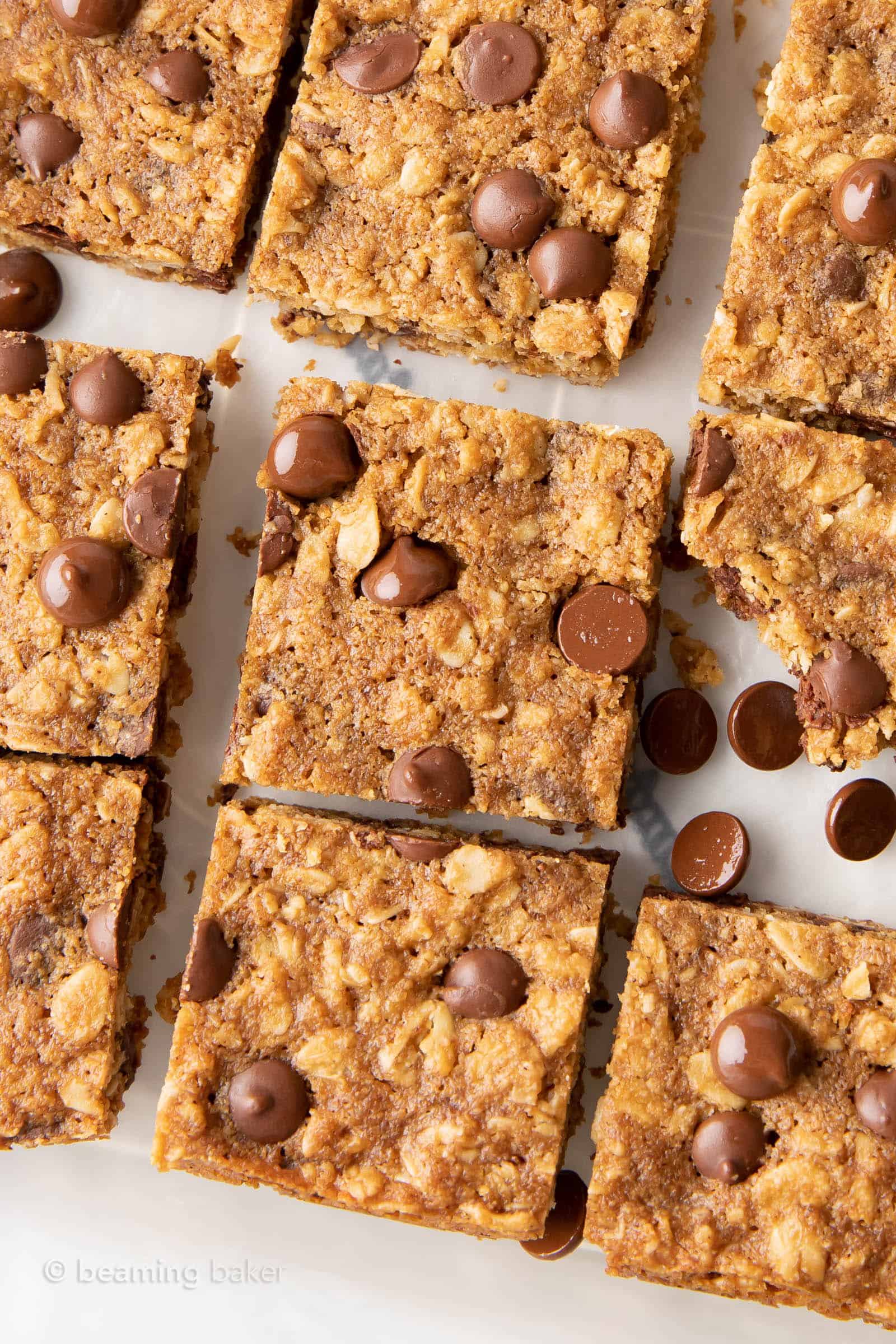 oatmeal cookie bars sliced and cooling on parchment paper