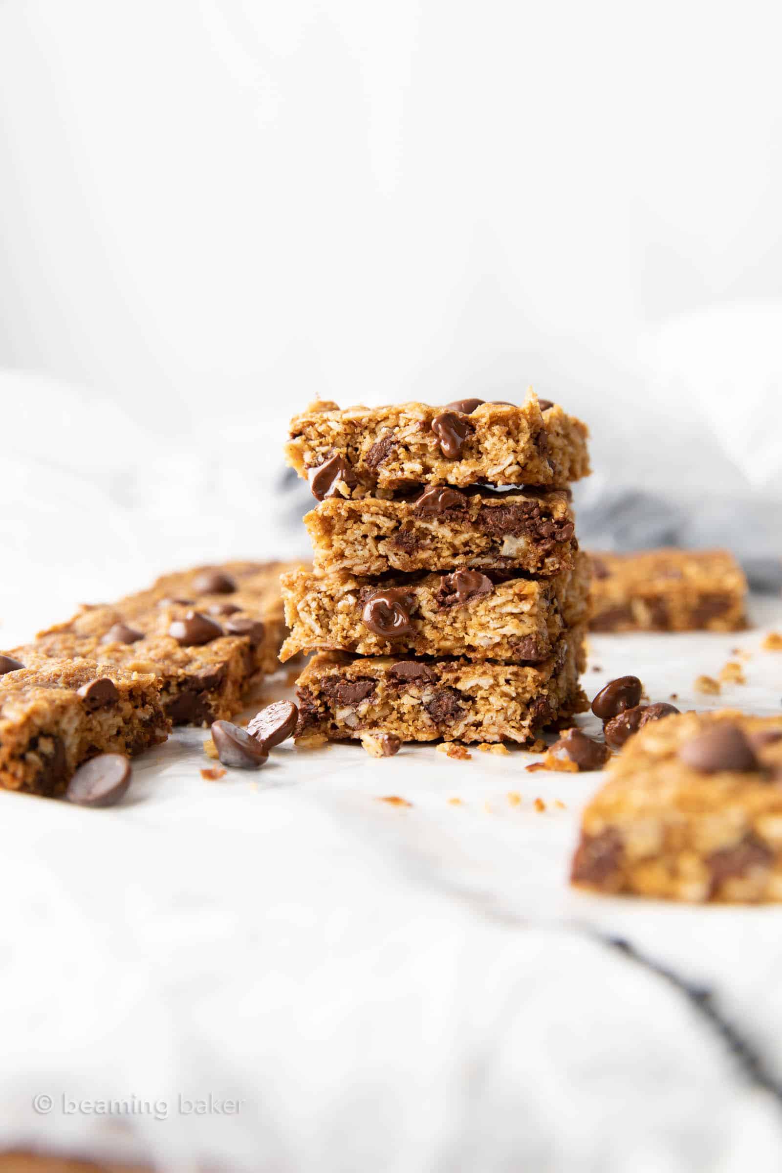 faraway stack of oatmeal chocolate chip cookies bars with more in background 