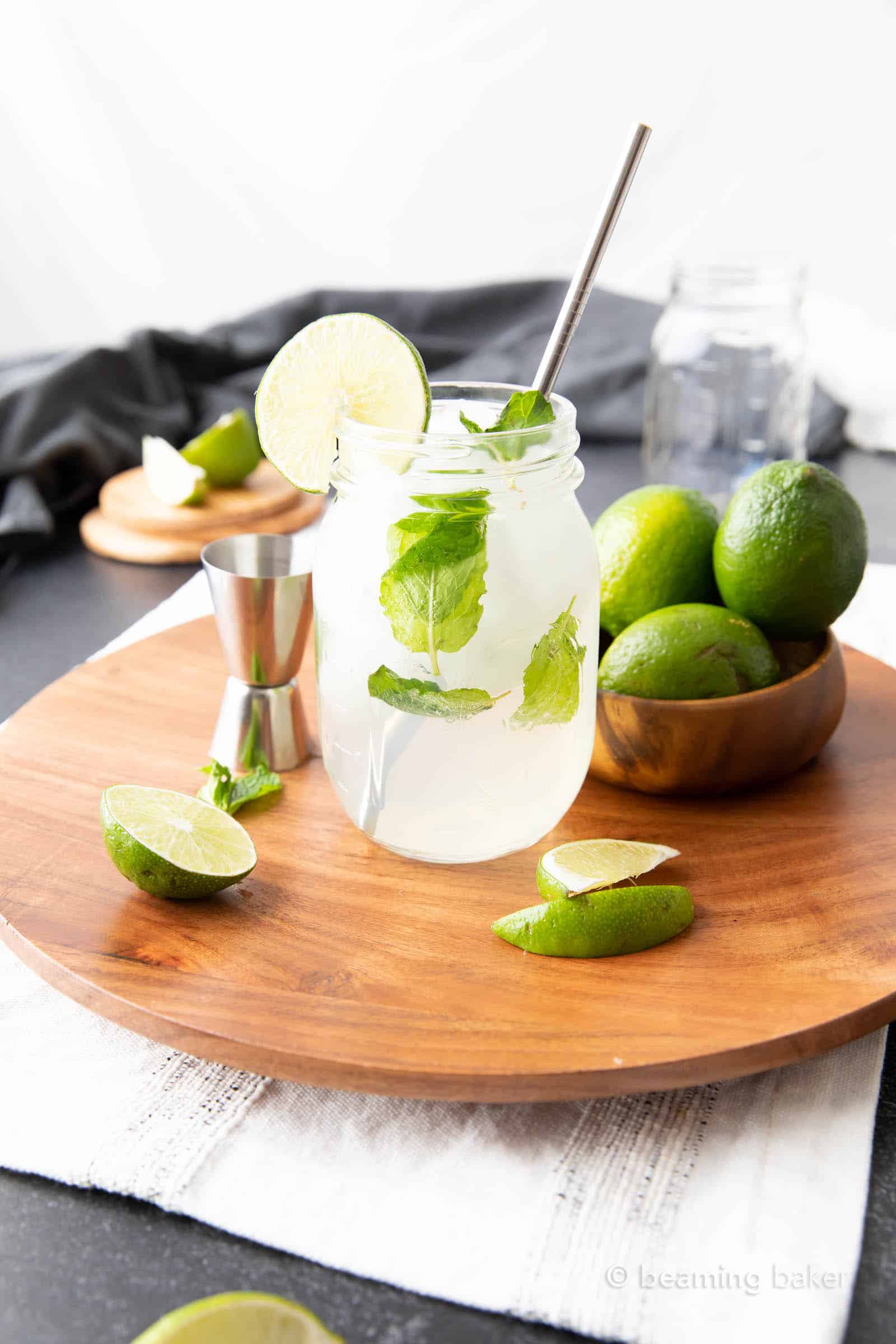 mojito mocktail with a lime wheel on a wooden tray