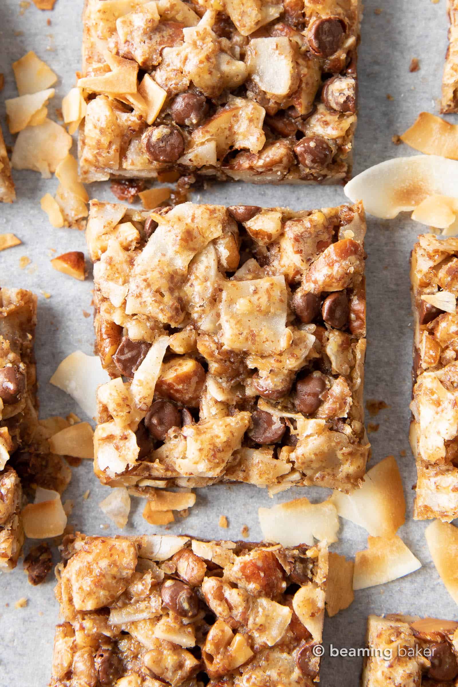 coconut granola bars cut into squares with coconut shreds
