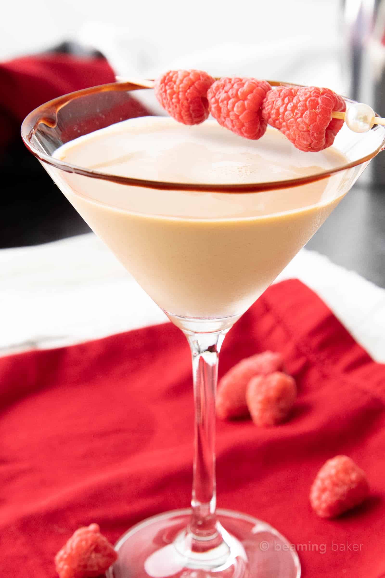 very closeup shot of one chocolate raspberry martini with a raspberry skewer