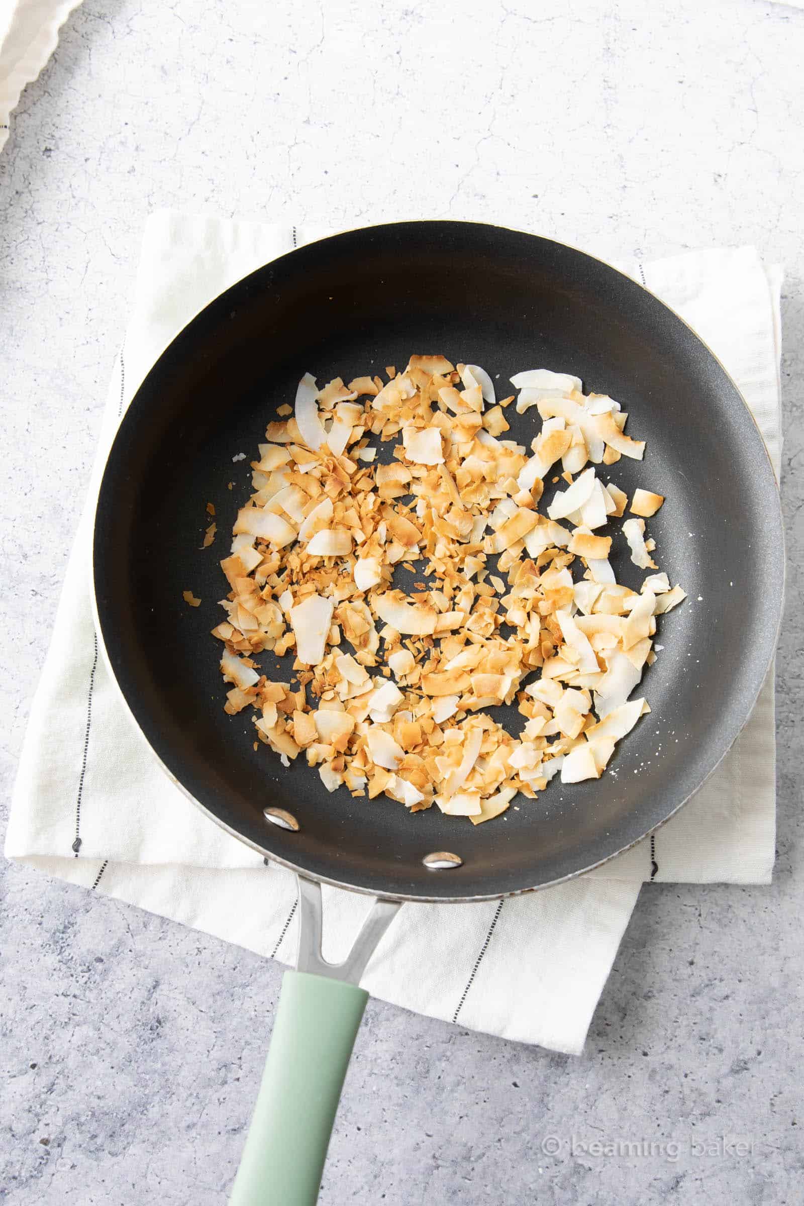 Cooling Toasted Coconut in Pan on a kitchen towel