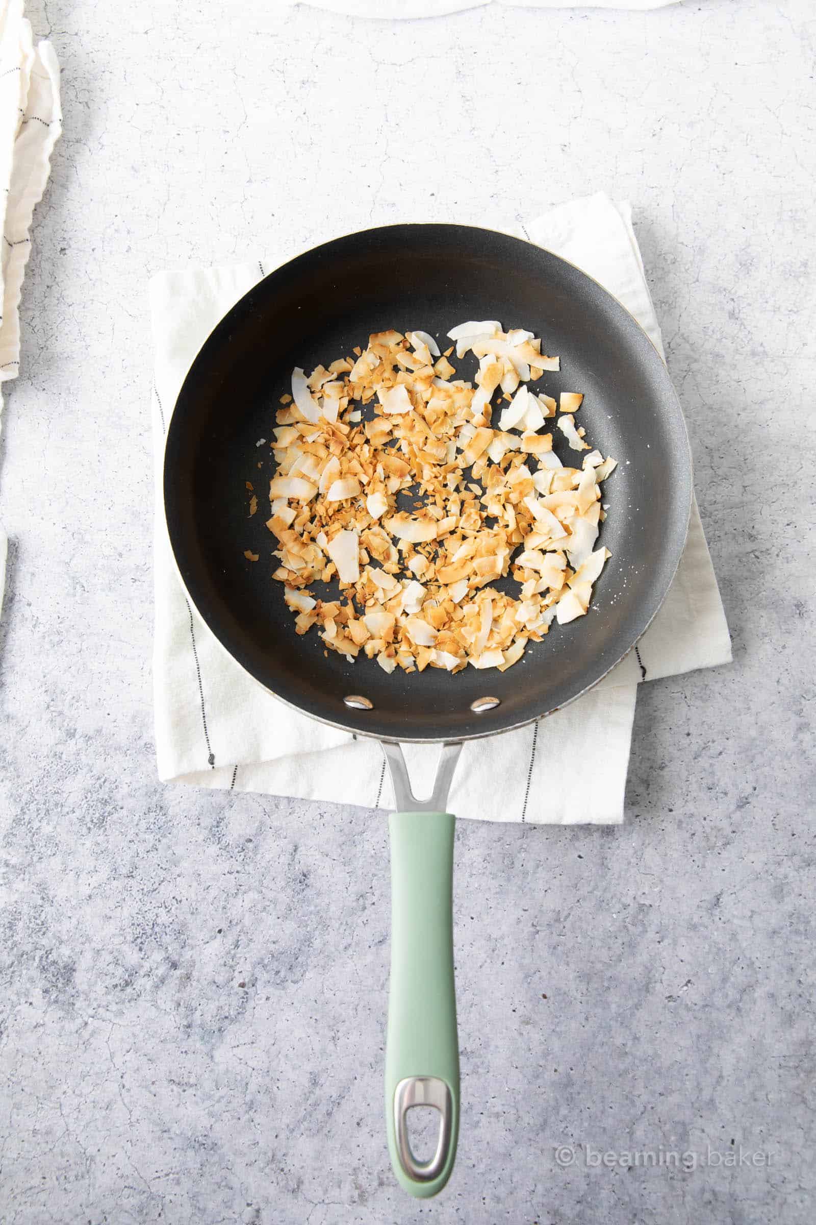 after toasting photo of toasted coconut in pan