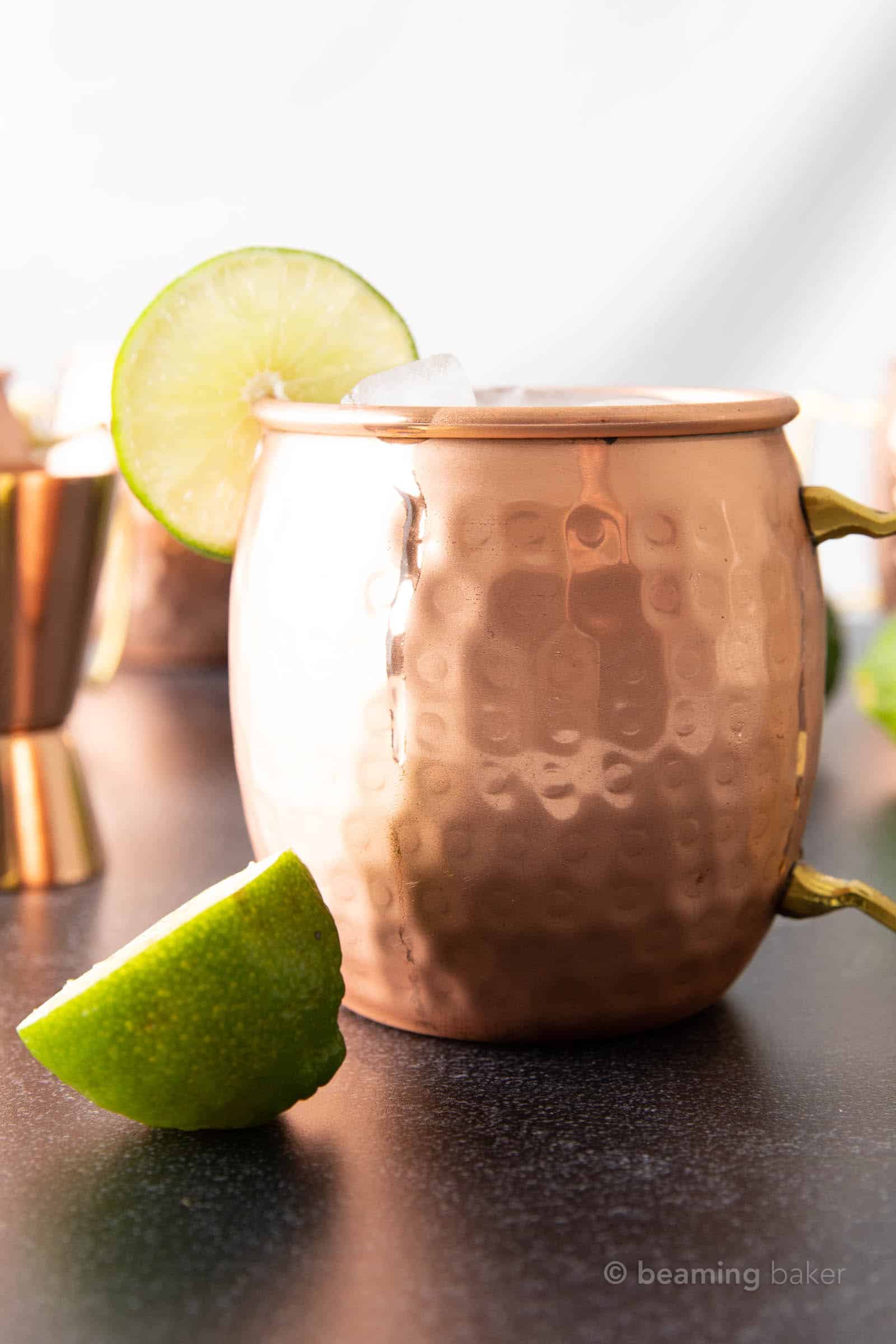 super closeup copper mule mug filled with Irish Mule cocktail with lime wheel