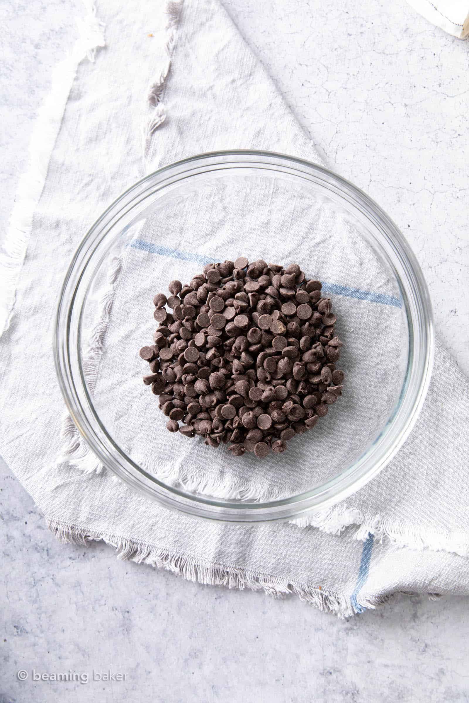 Dark chocolate chips in a glass bowl