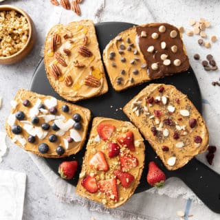 Five kinds of peanut butter toast recipe laid out on a black serving board