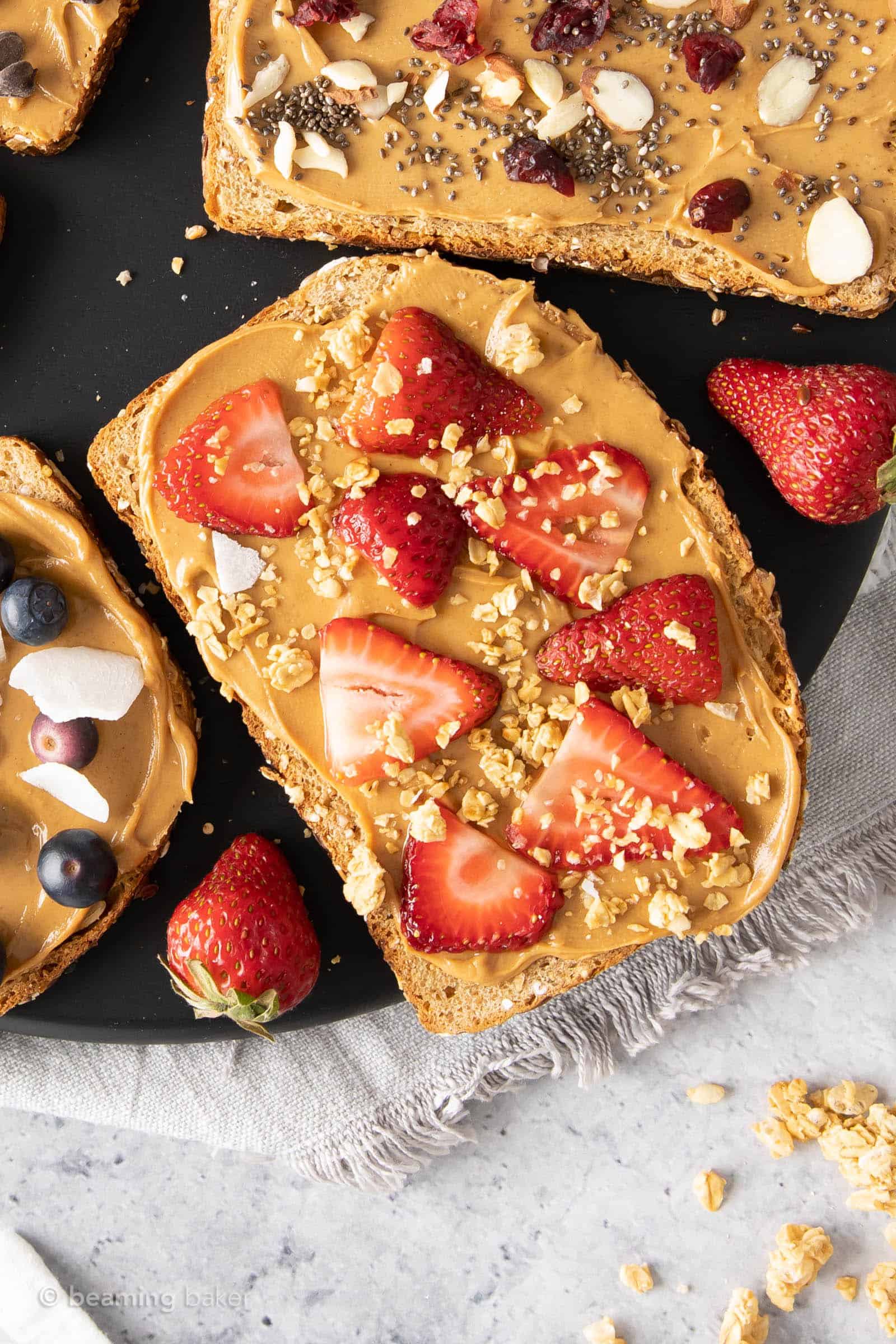 Strawberry Granola peanut butter toast topped with strawberry slices and granola sprinkled on