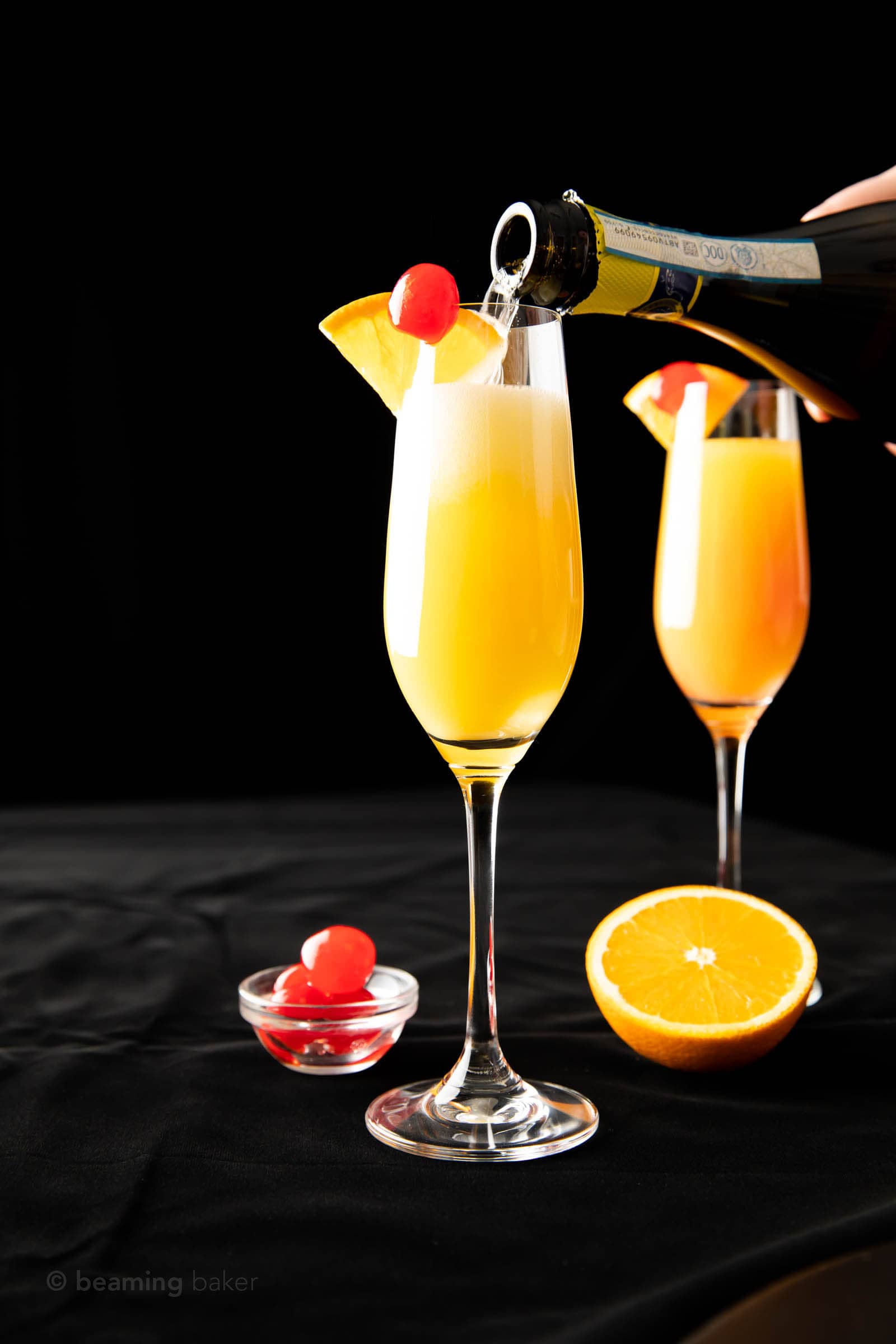 far shot pouring prosecco for mimosa with grenadine