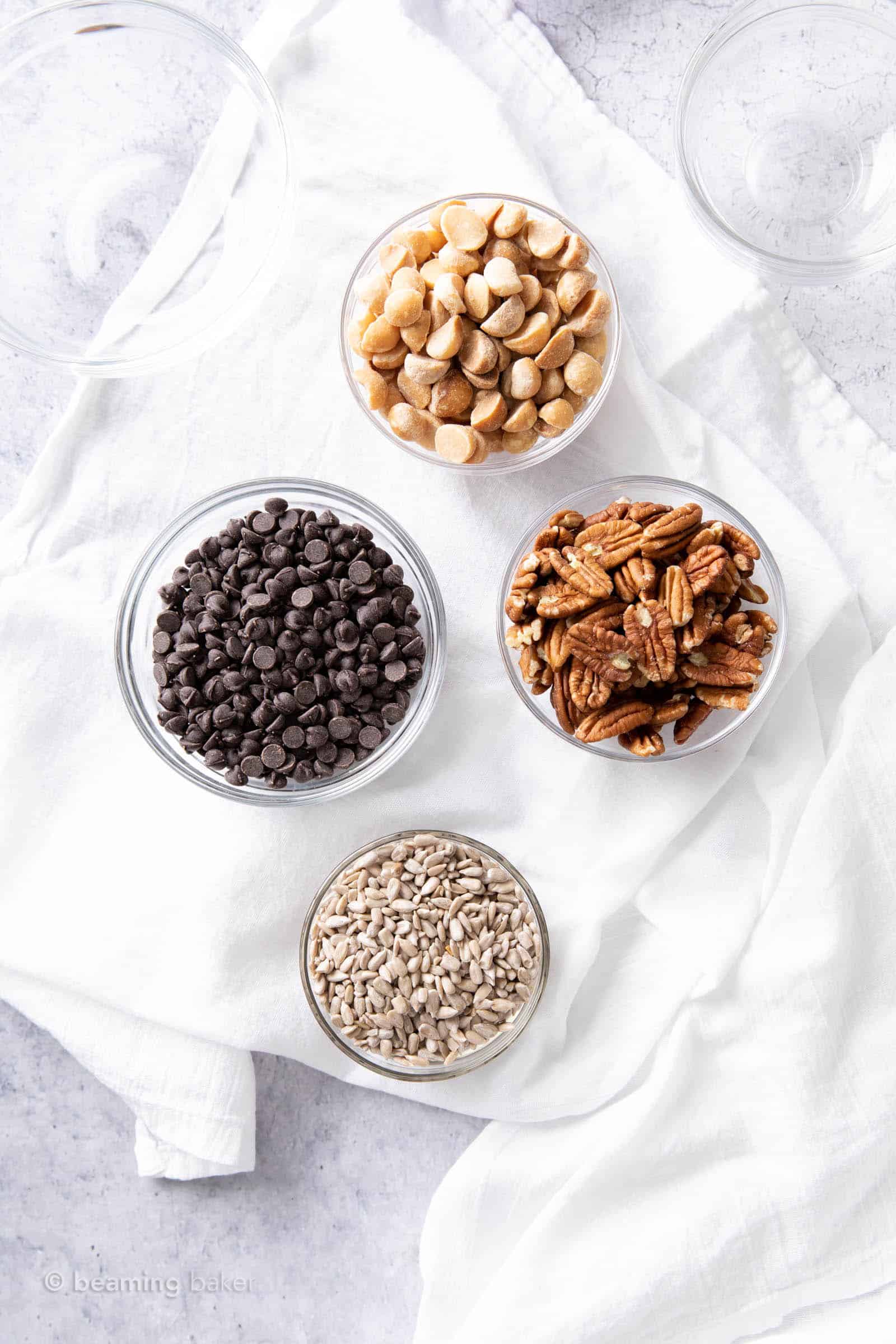 the ingredients for the best keto trail mix in glass prep bowls
