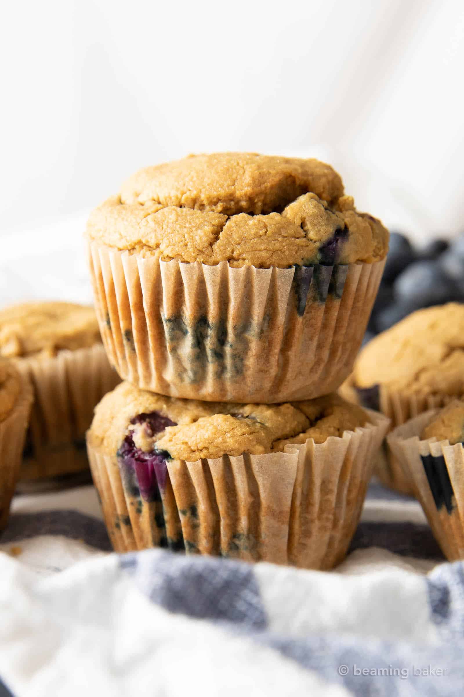 Two oat flour blueberry muffins stacked on top of each other