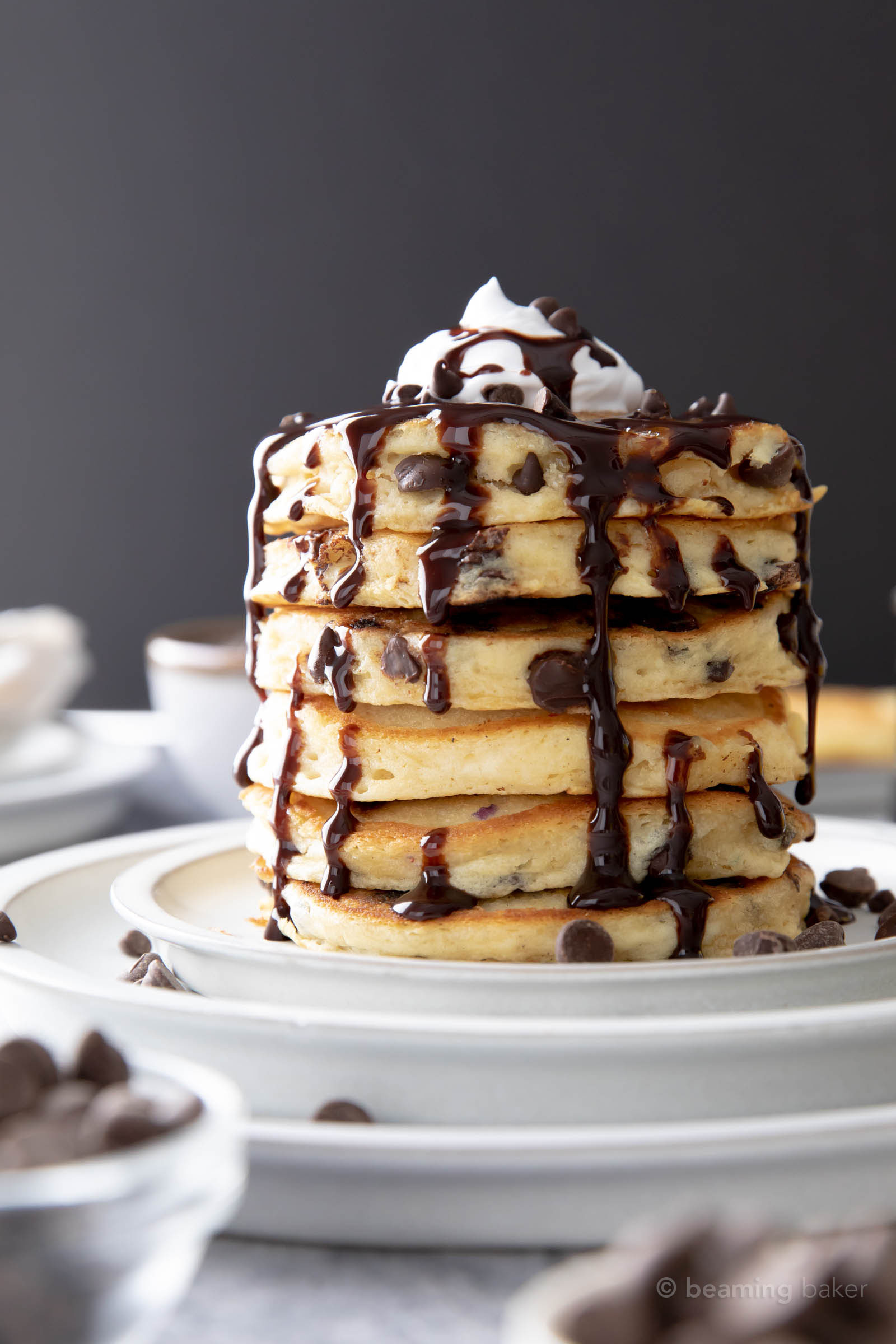 Stack of vegan chocolate chip pancakes on stone plate