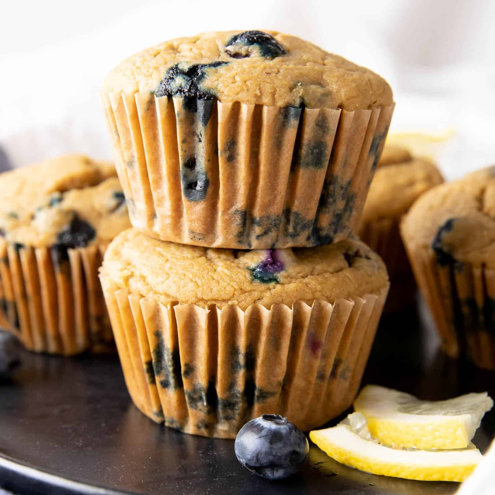 lemon blueberry gluten free vegan muffins stacked on top of each other