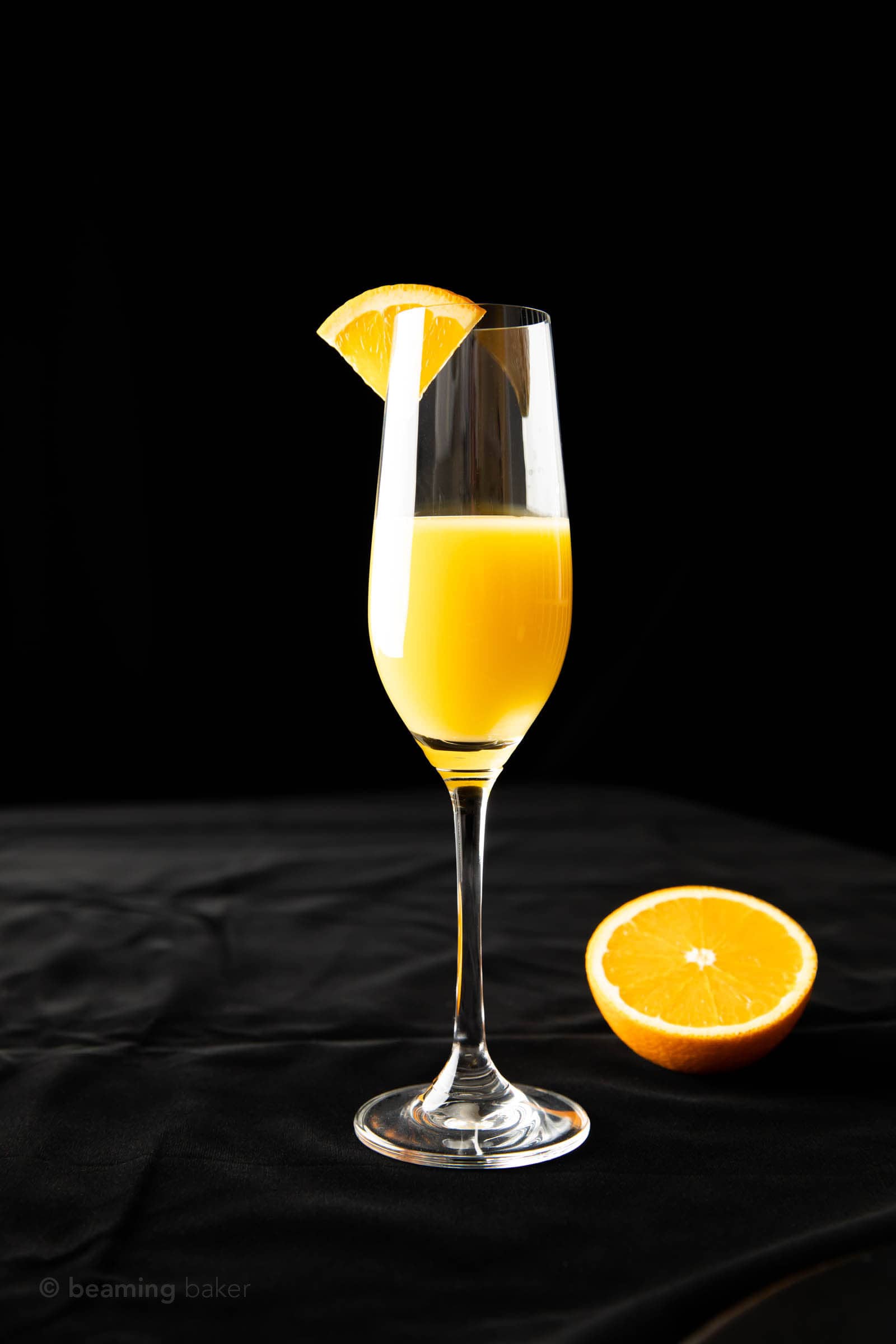 a half-filled a glass of fresh orange juice and top with an orange wedge