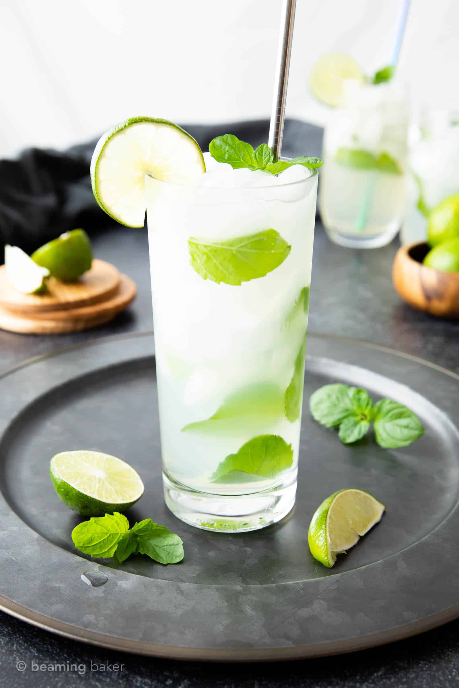 classic mojito in a highball glass with a silver straw and lime wedge garnish