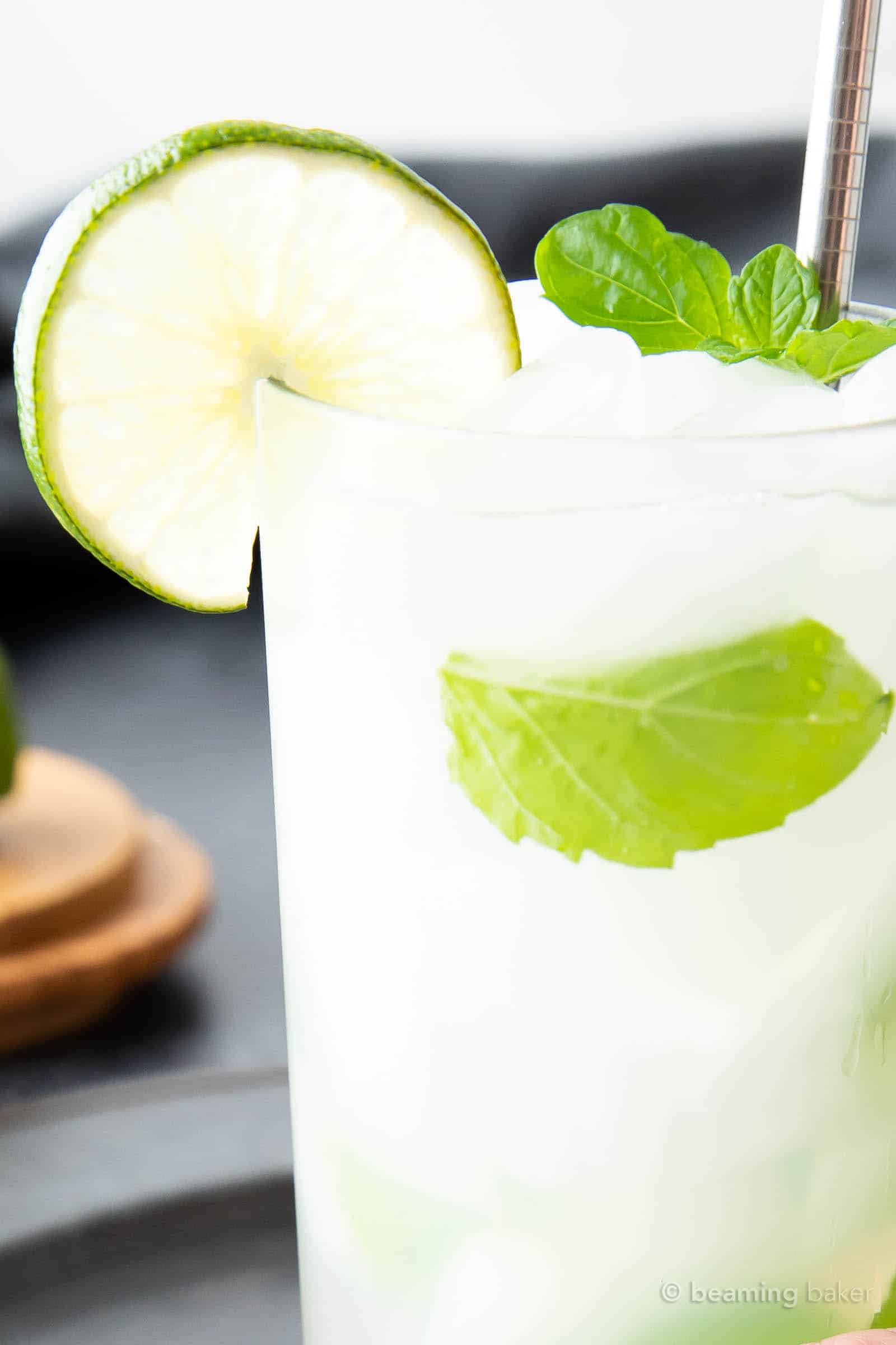 super closeup shot of a classic mojito drink with mint leaves and fresh lime