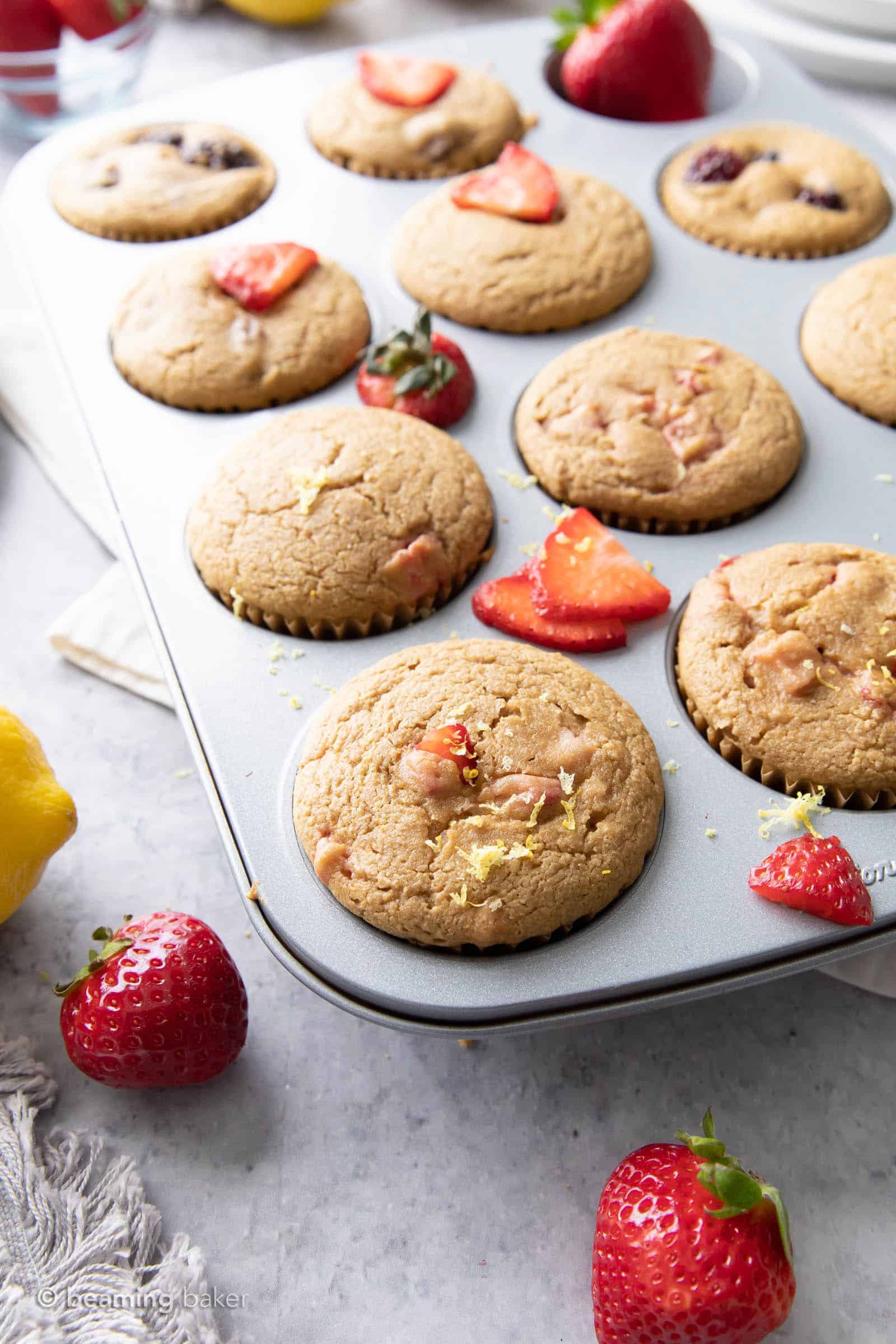 closeup angled muffin pan filled with strawberry lemon muffins