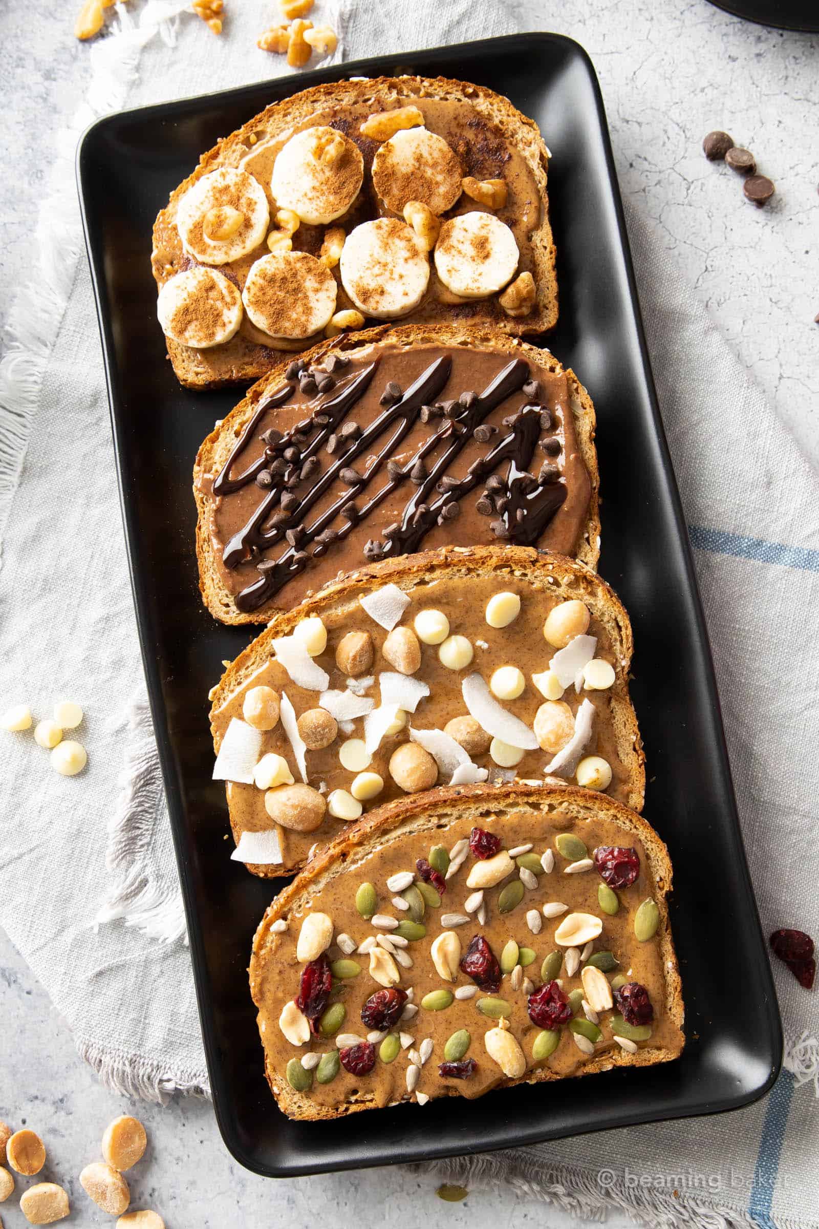 Closeup of almond butter toast recipes on a black ceramic serving plate