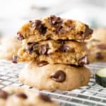 Stack of three zucchini chocolate chip cookies on a cooling rack