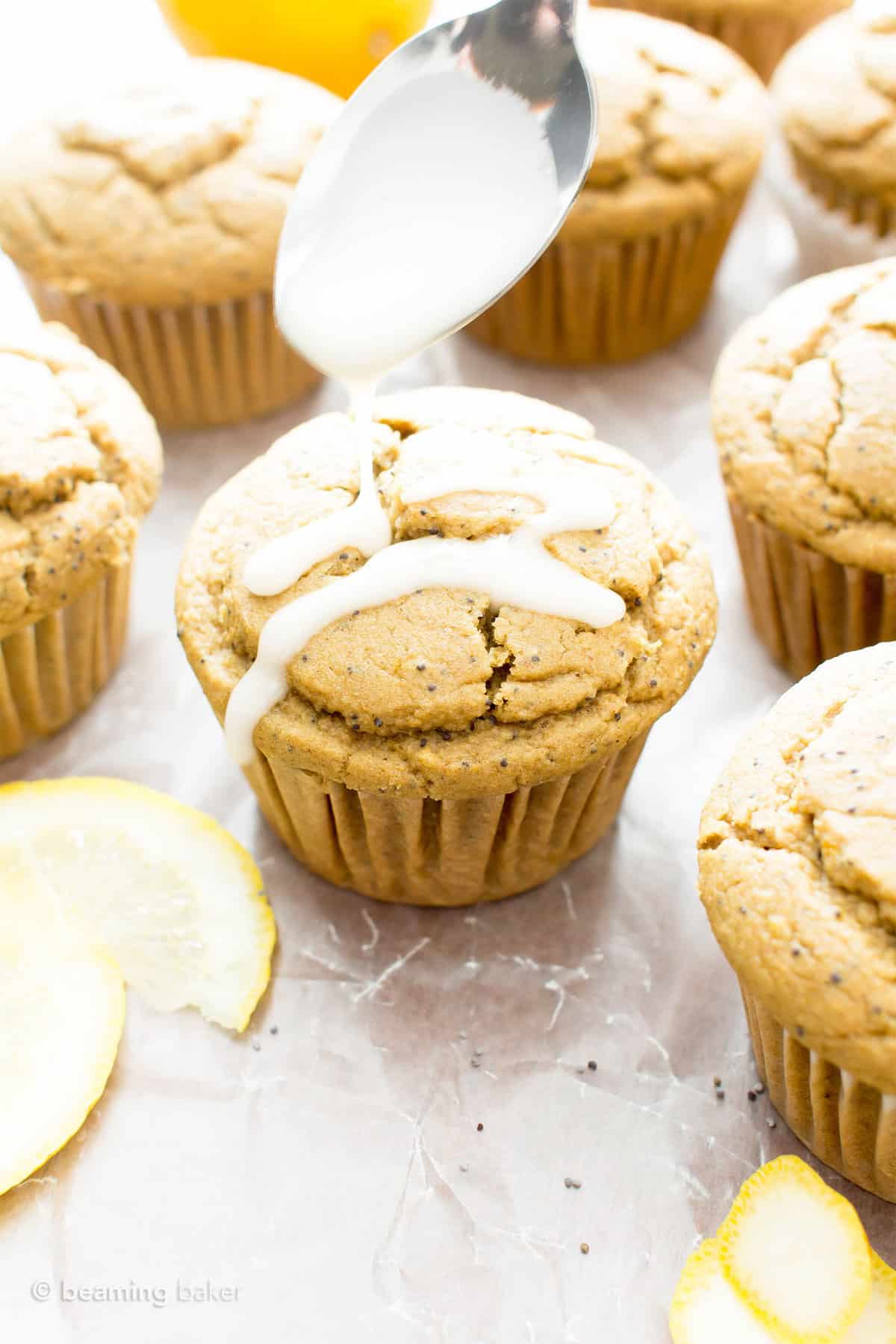 Spooning lemon glaze onto muffins