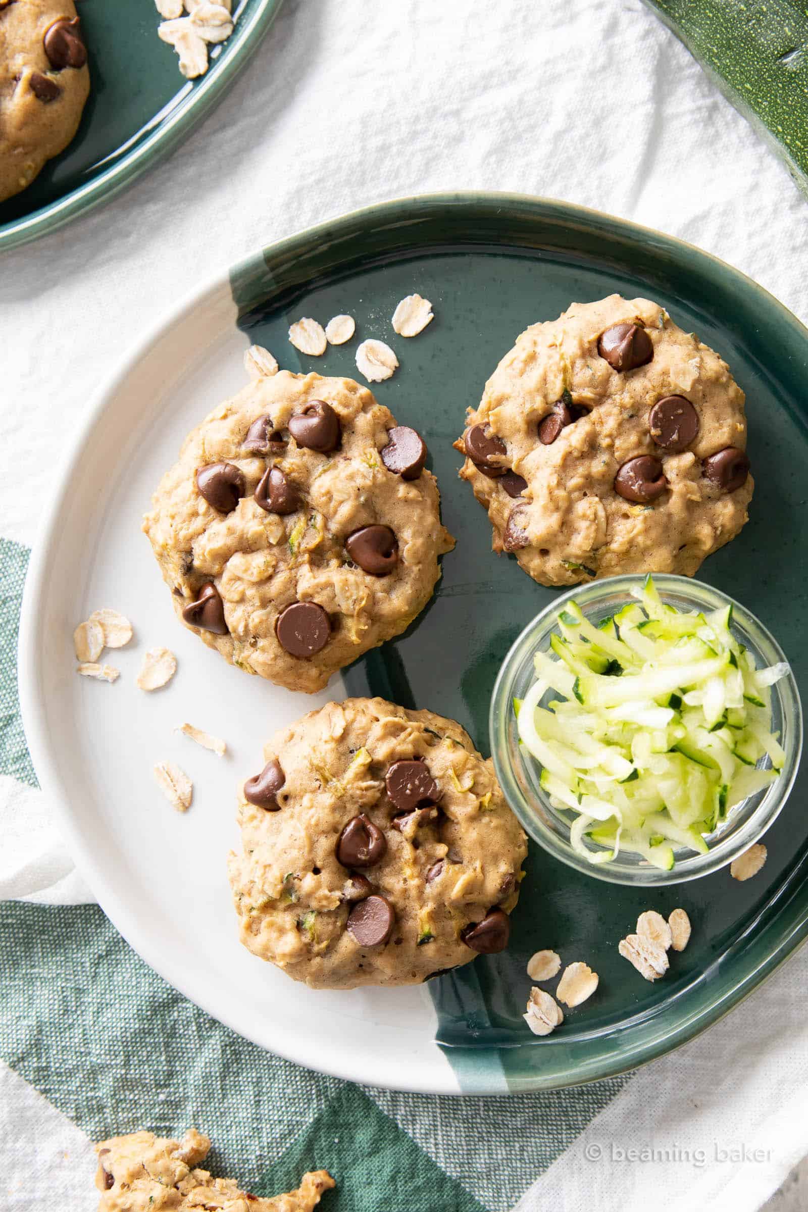 Three zucchini oatmeal cookies on a green and white plate
