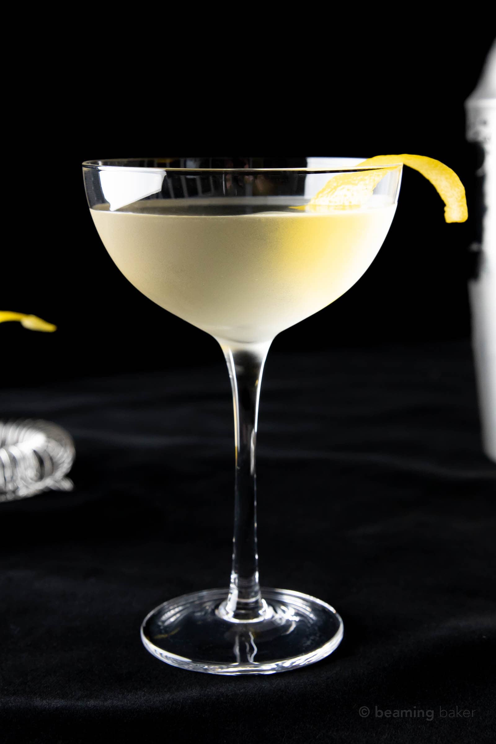 a 50 50 martini in a coupe glass garnished with a lemon peel