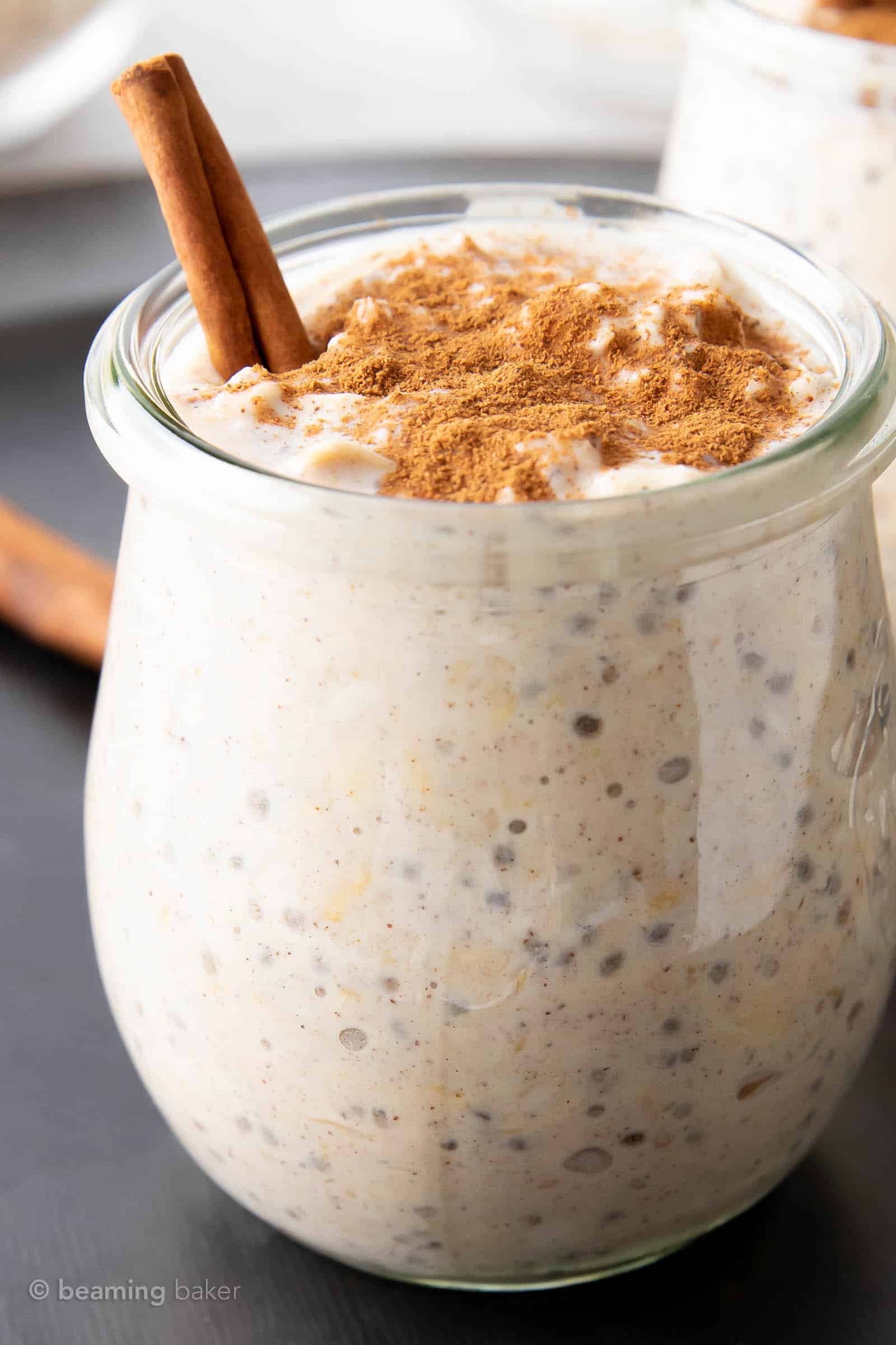 closeup, detailed shot of cinnamon sprinkled on top of cinnamon overnight oats in a glass jar