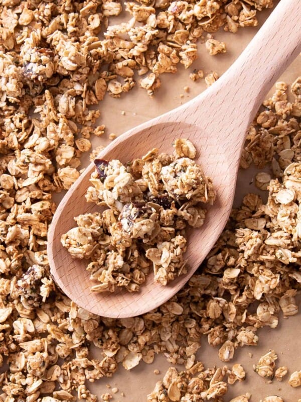 Hemp seed granola clusters on a spoon surrounded by more granola