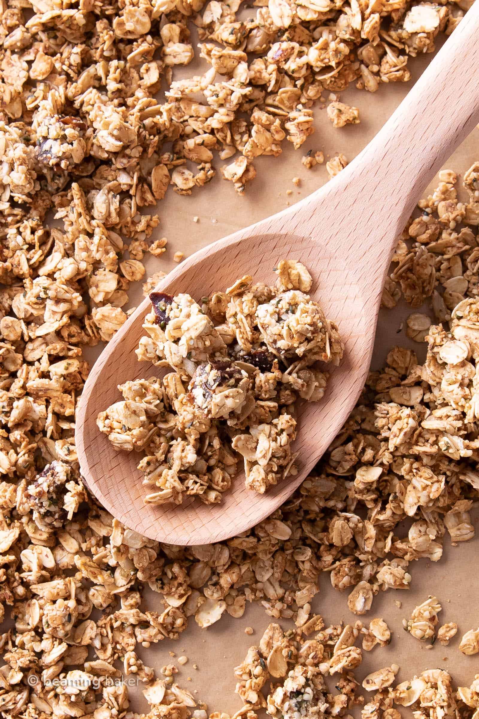 Hemp seed granola clusters on a spoon surrounded by more granola