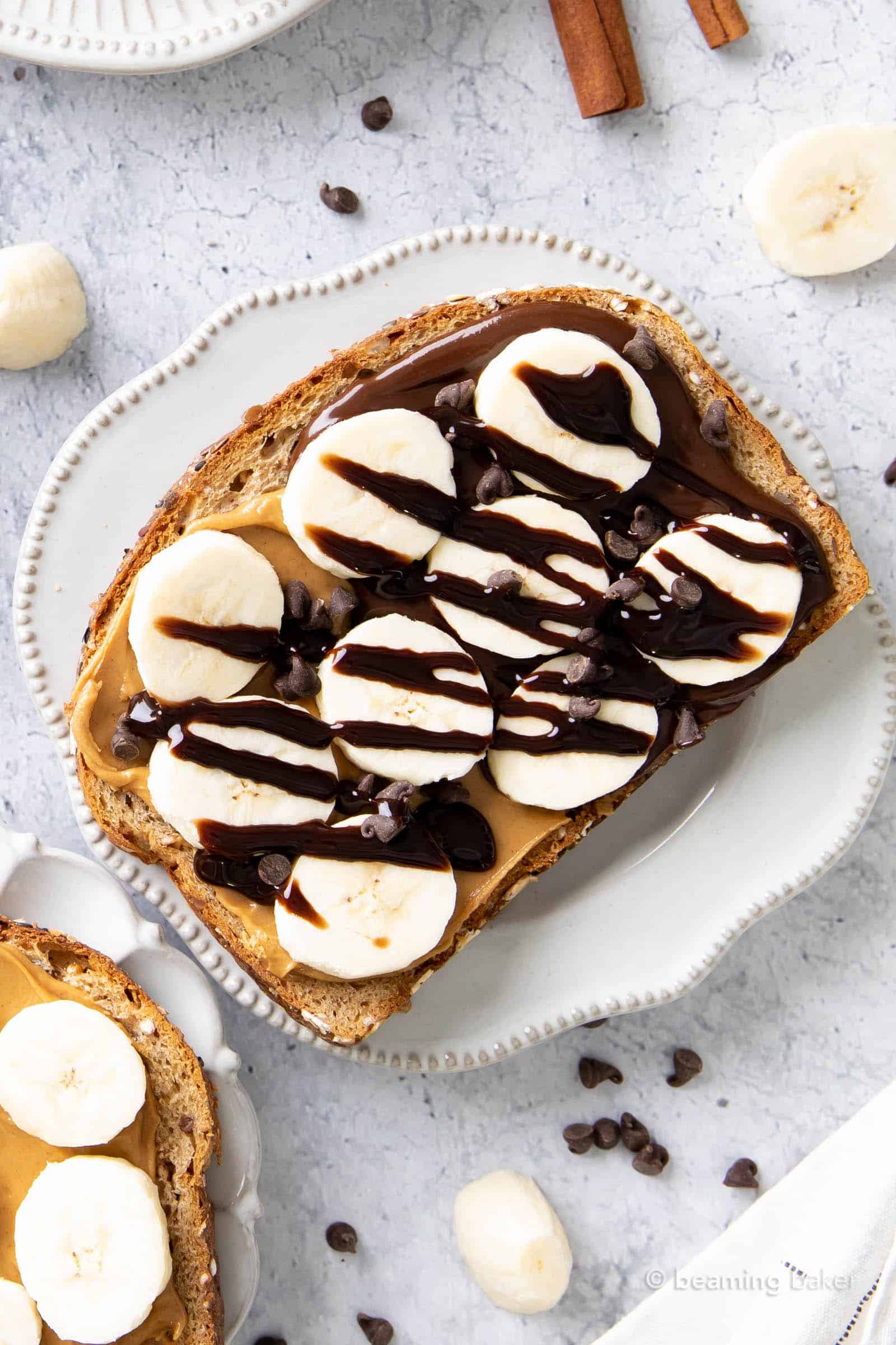 chocolate peanut butter and banana toast topped with chocolate syrup
