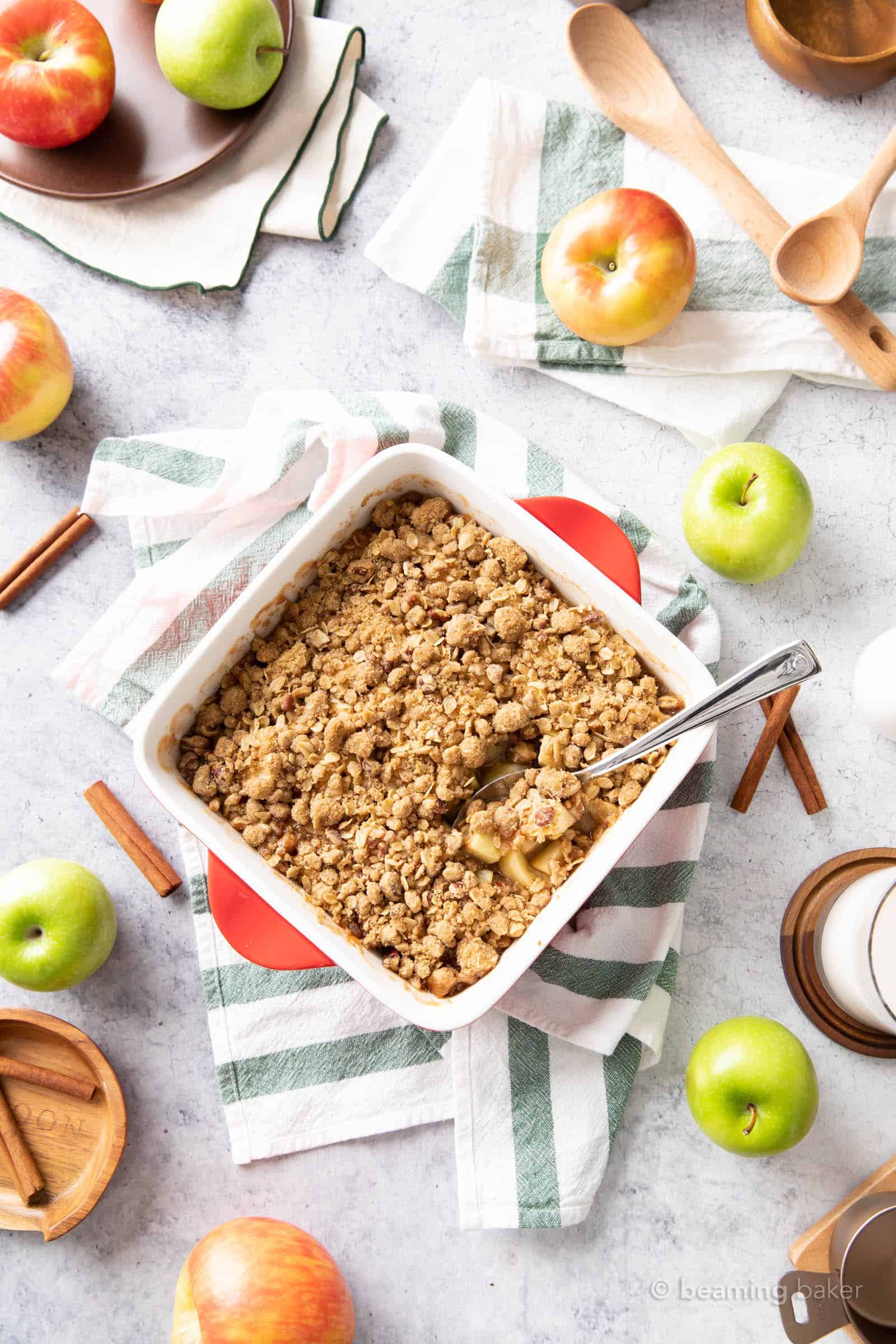 kitchen table with fresh baked apple crumble in on top of green striped towels