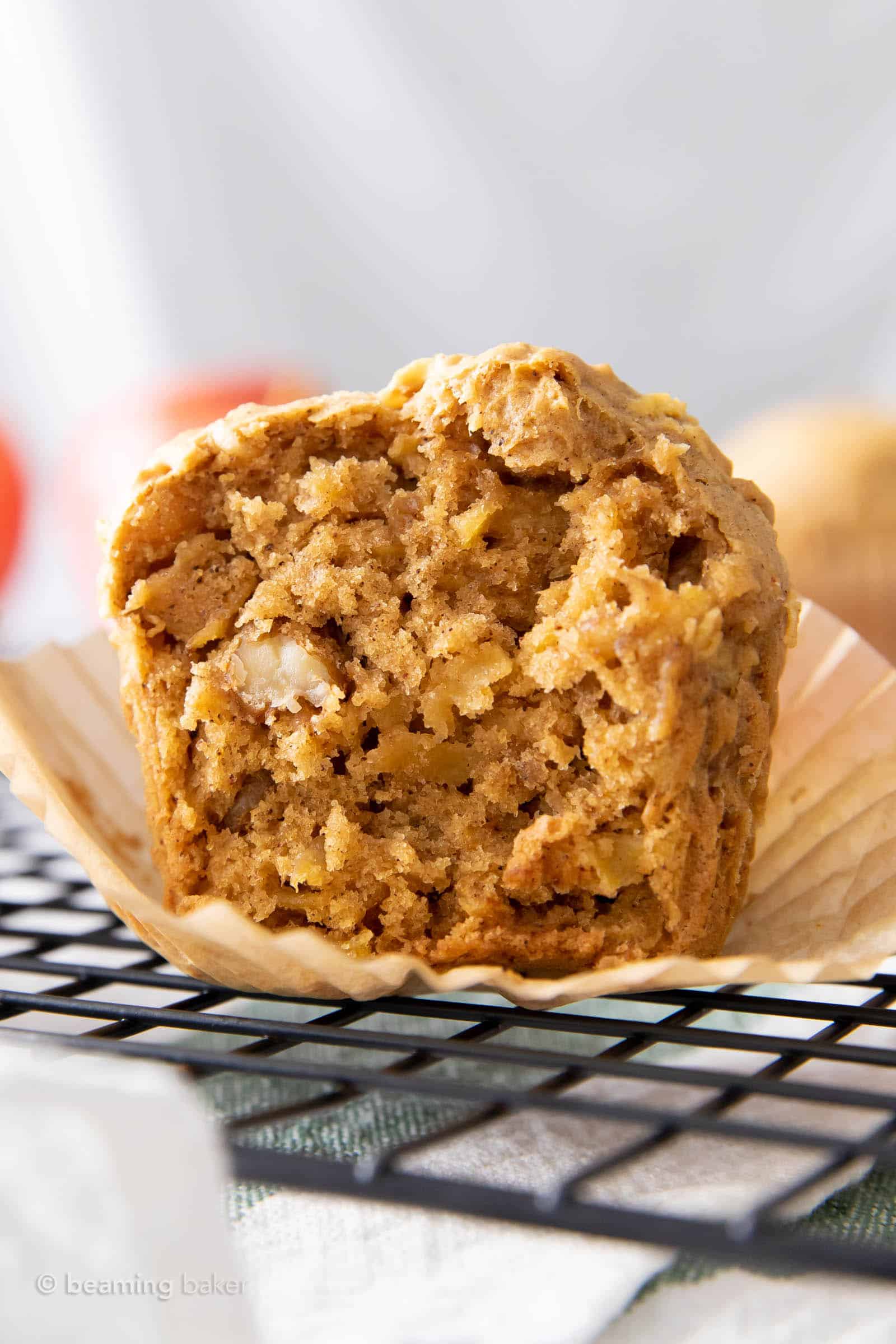 Super closeup shot of vegan apple muffin split in half on a cooling rack