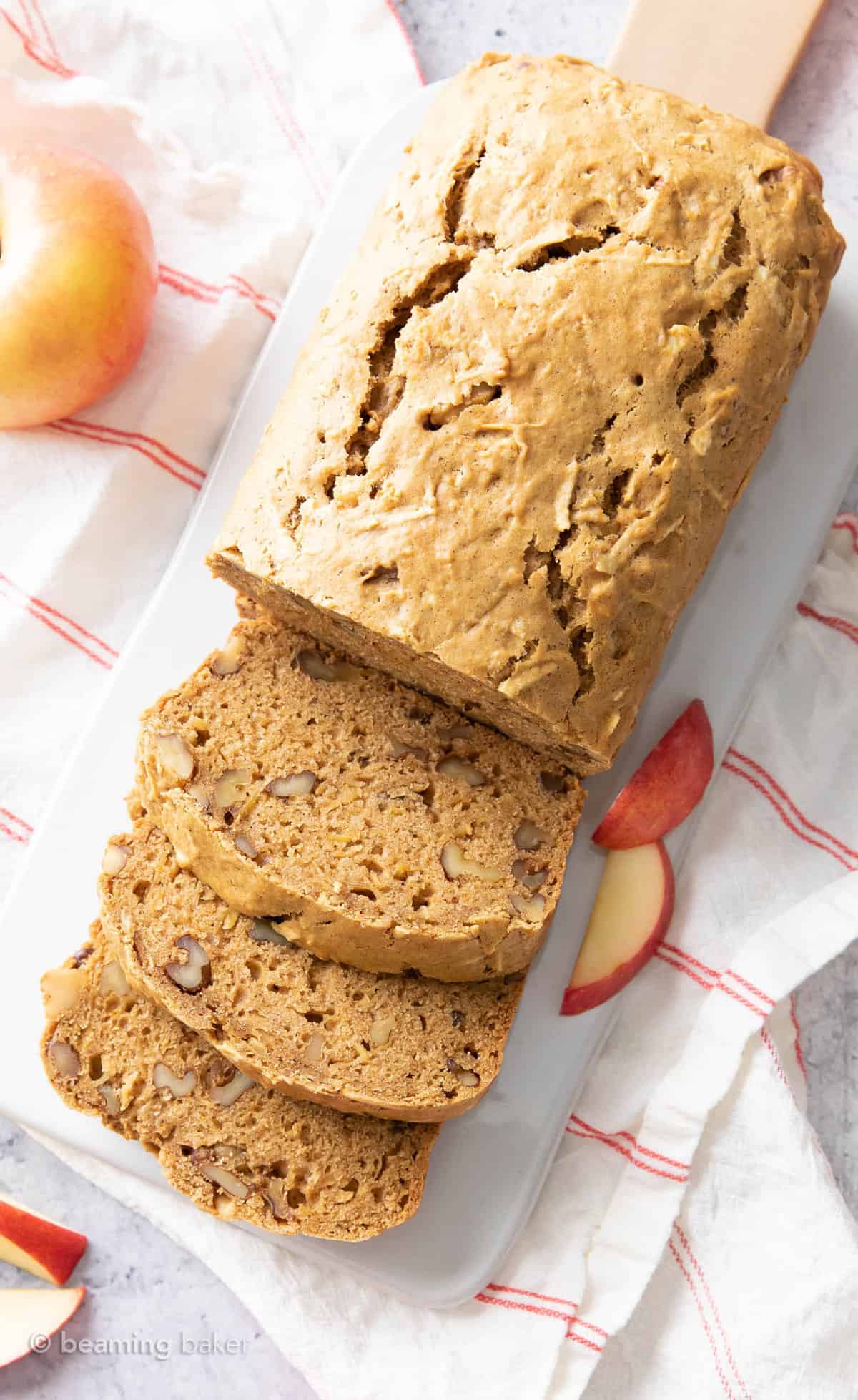 Overhead shot of the apple bread recipe on a serving board with apple slices