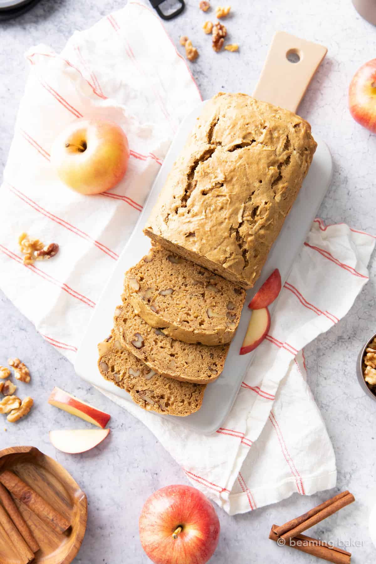 Fresh-baked loaf on a kitchen table with ingredients and baking tools