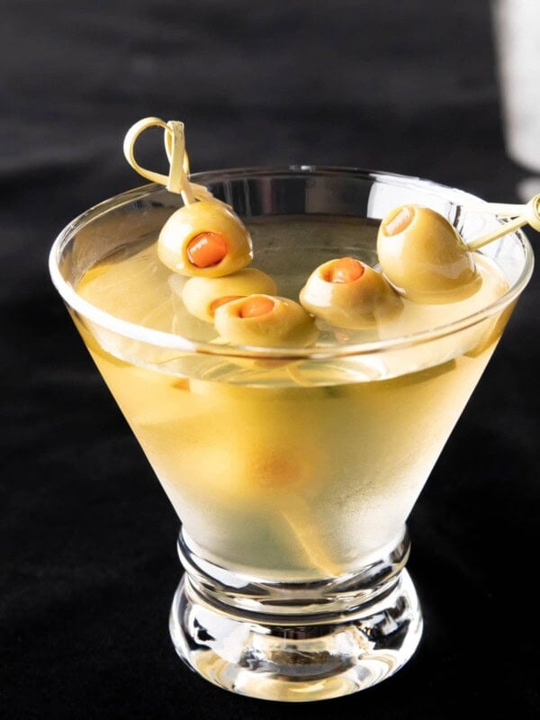 Two olive skewers in an extra dirty martini