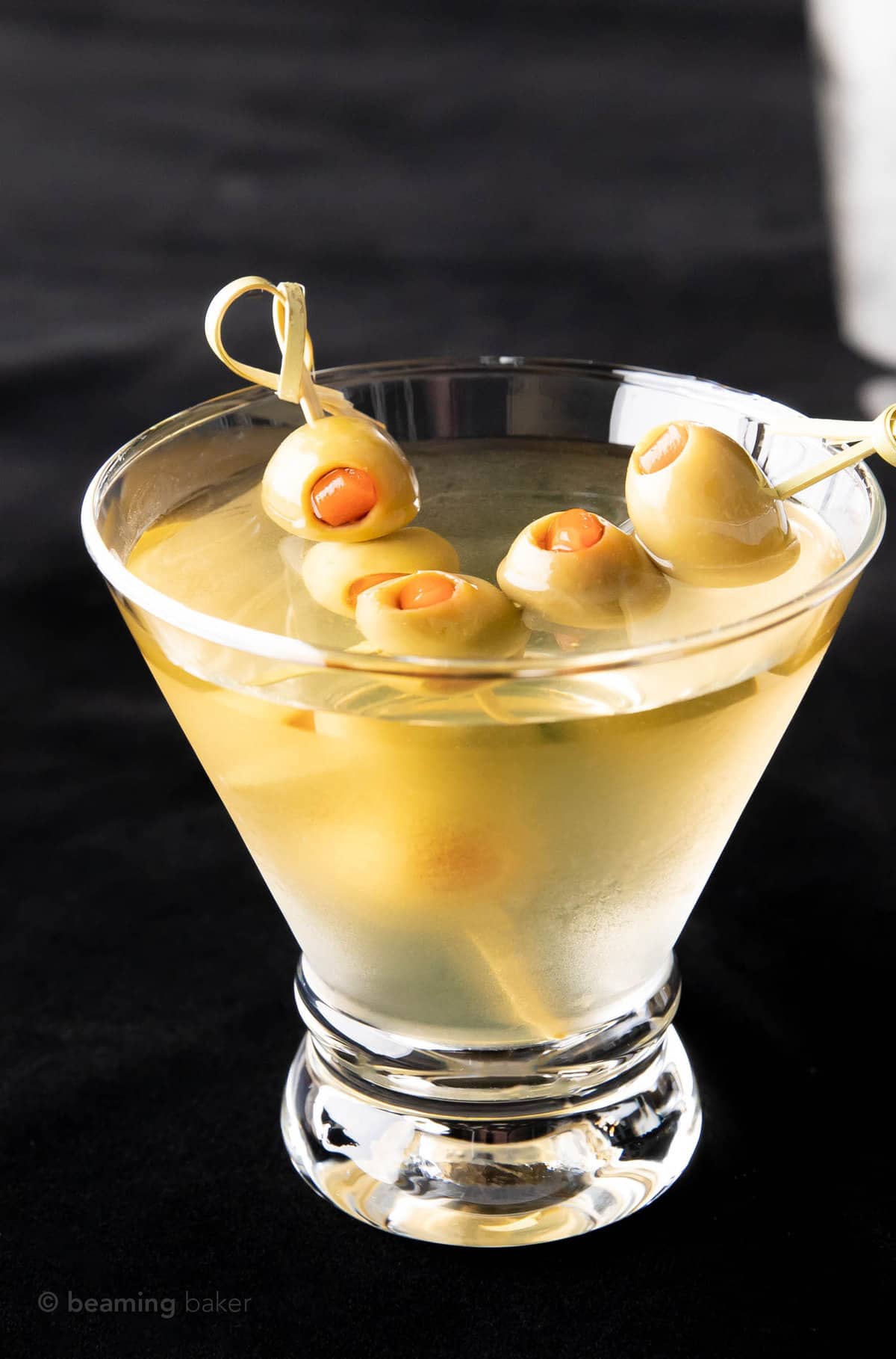 Two olive skewers in an extra dirty martini