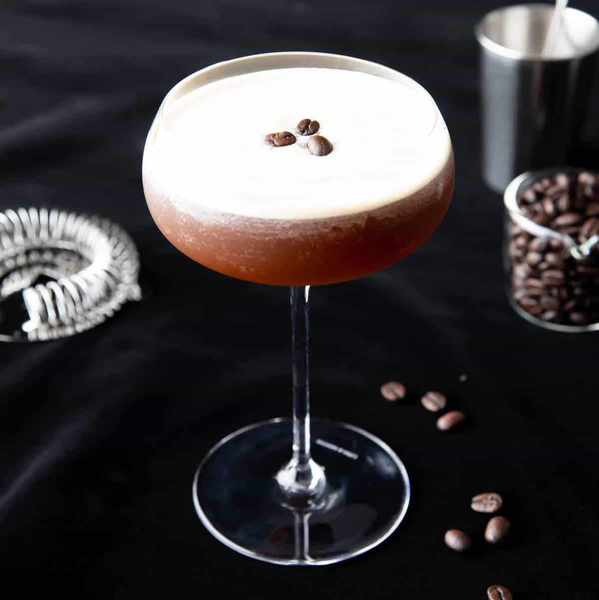 Coffee Martini topped with froth and three espresso beans