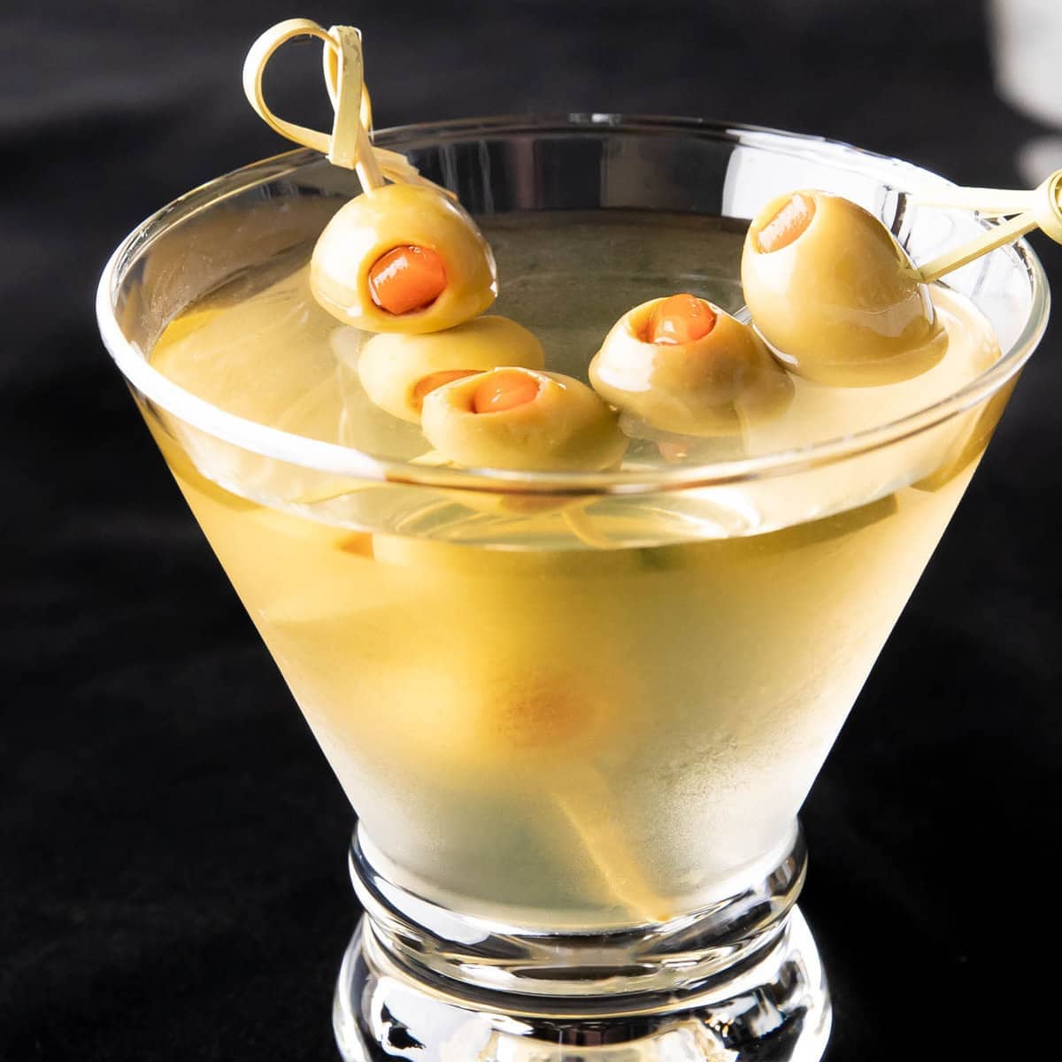 Extra Dirty Martini served in a chilled glass with two olive skewers