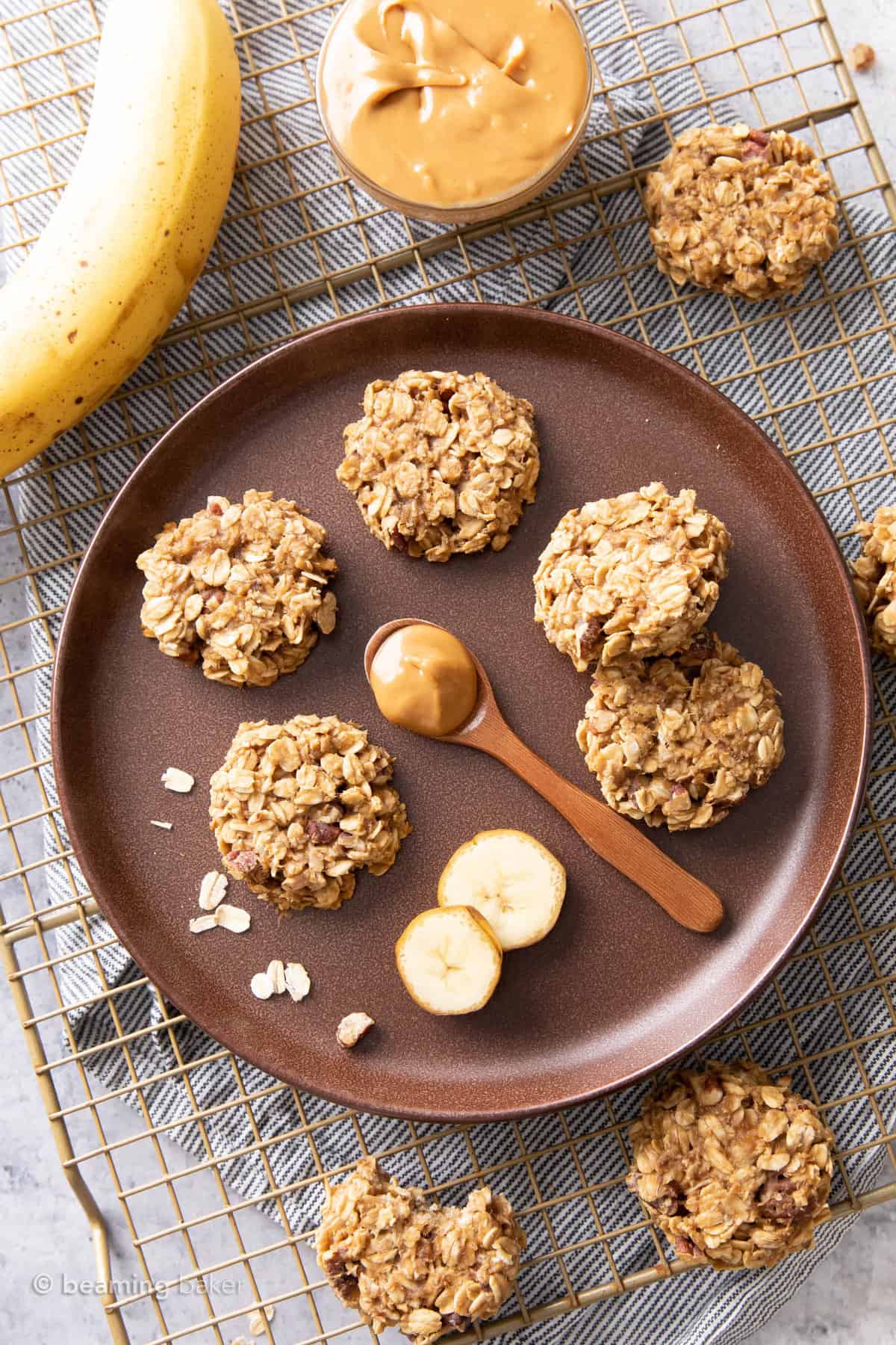 cookies on a plate with a wooden spoon of peanut butter