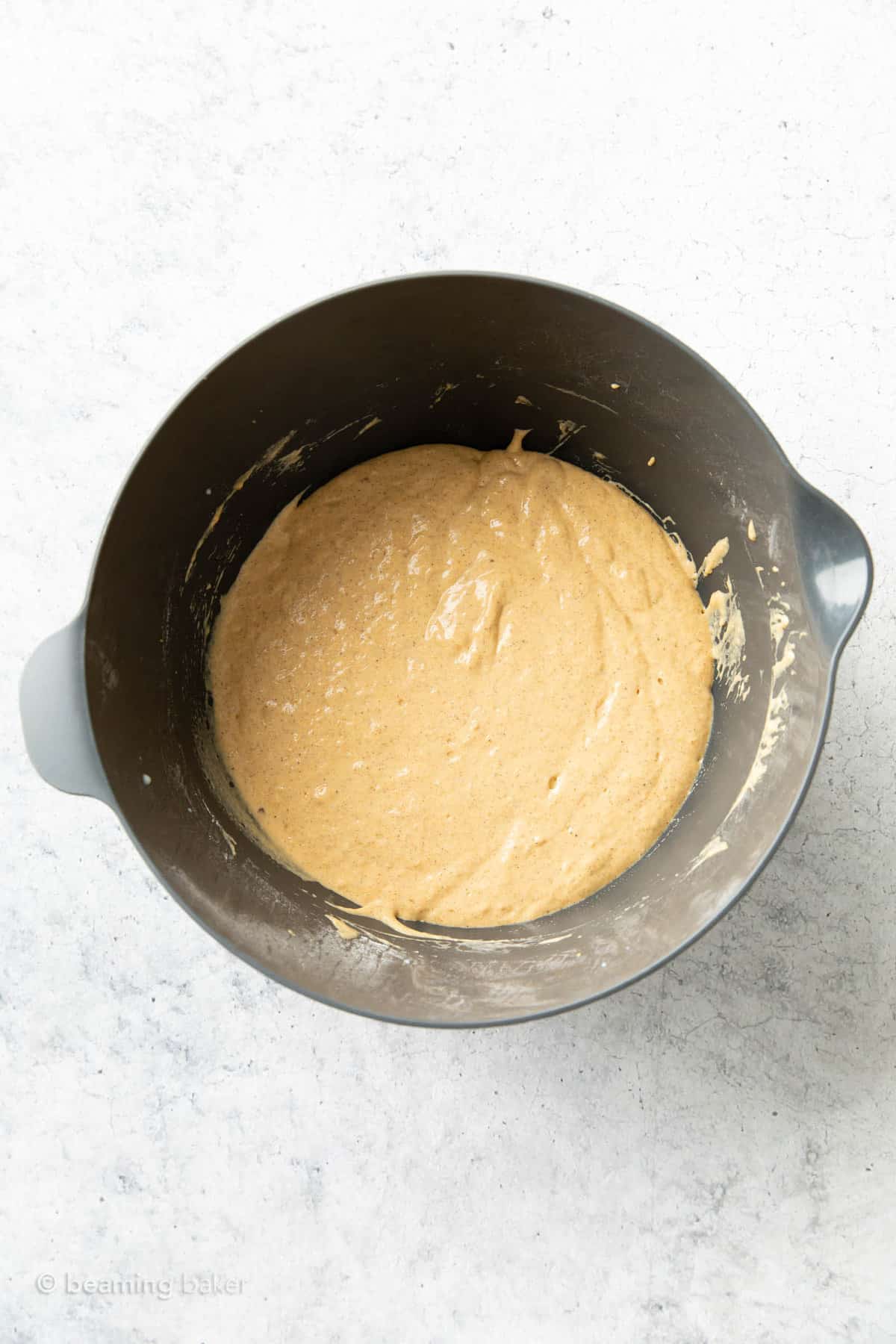 Pumpkin spice pancake batter in a gray mixing bowl